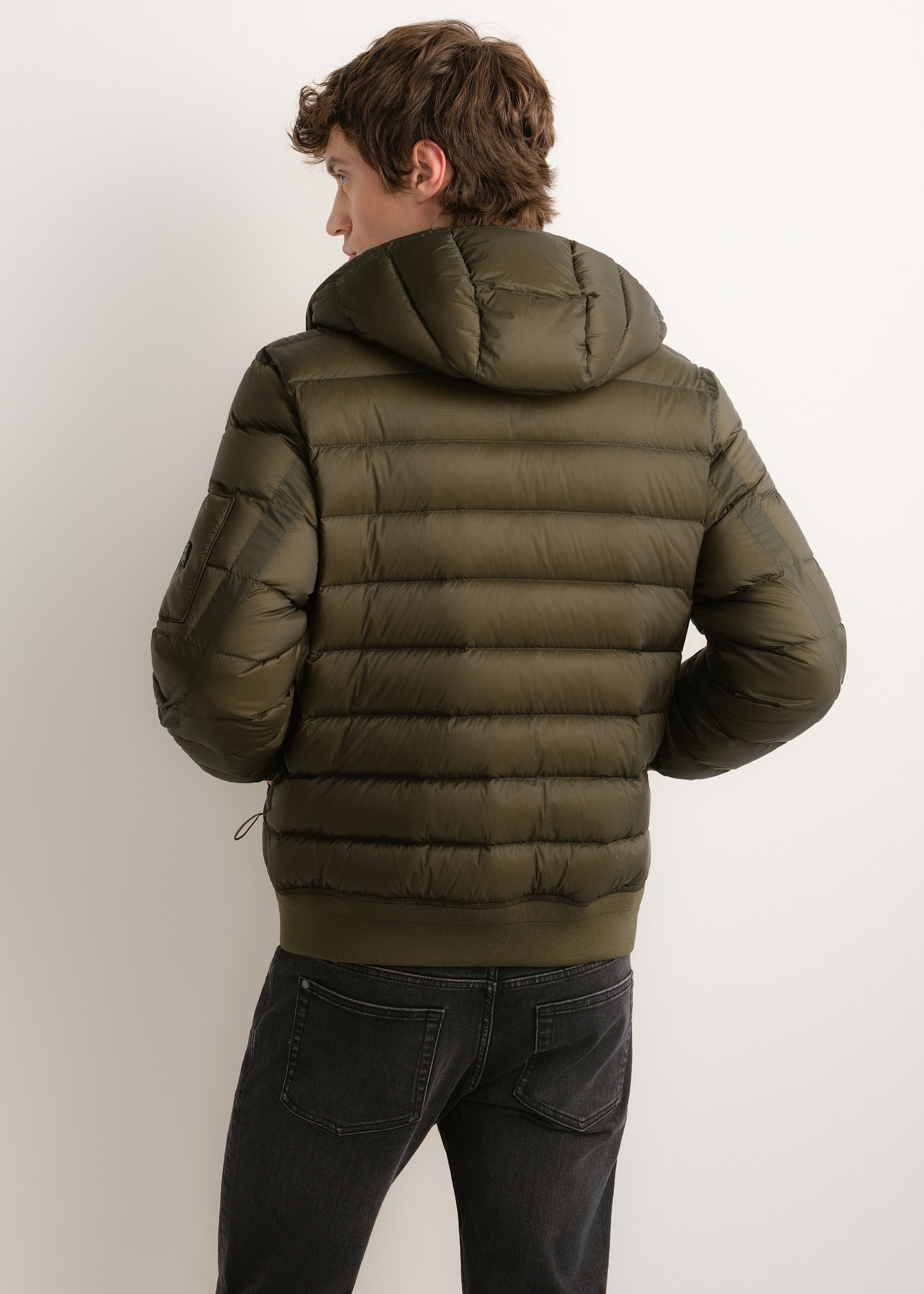 Men's green nylon jacket KURMT-0608-8B(Z26), product view from the back on the model. Half of the silhouette visible.