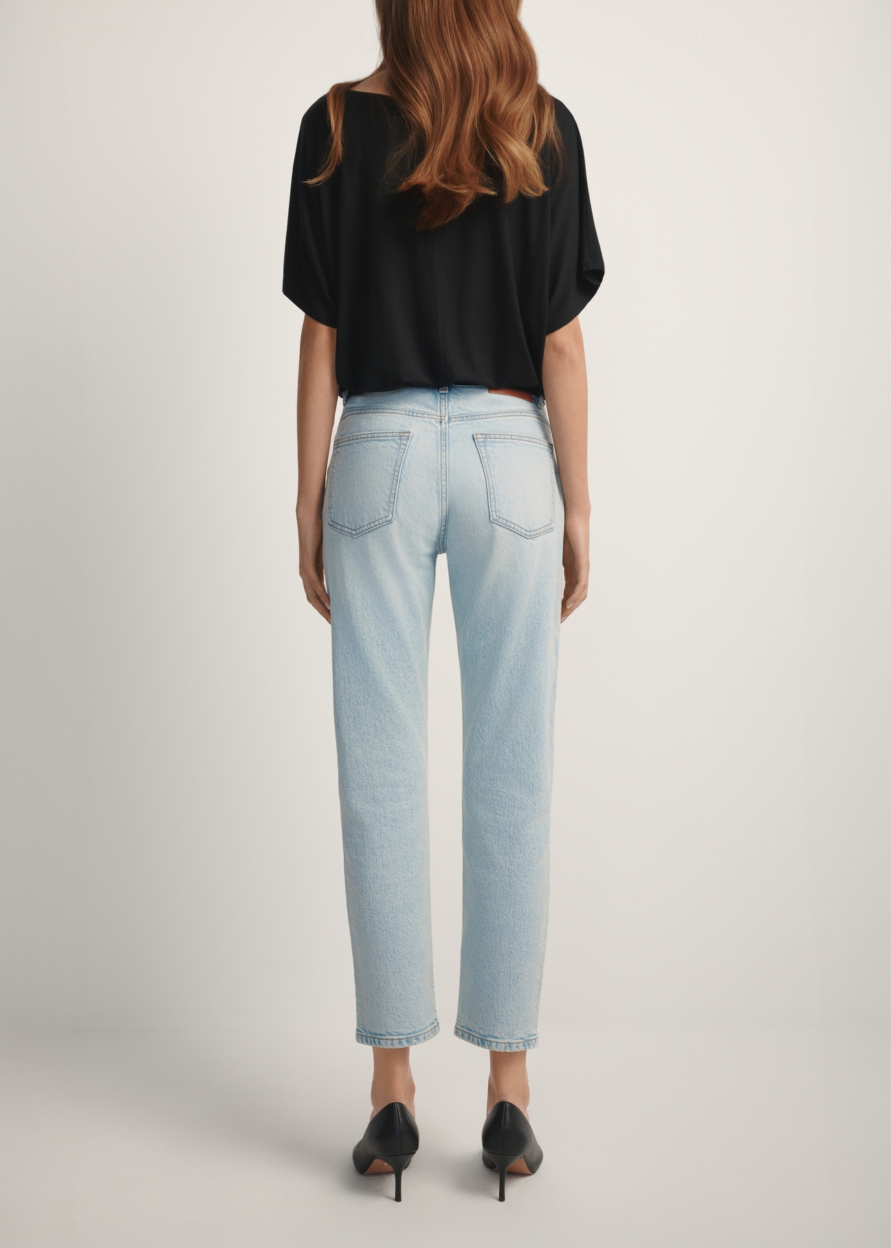 Light blue women's jeans JEADT-0011-7A(W26), back view of the product on the model. Half of the silhouette visible.