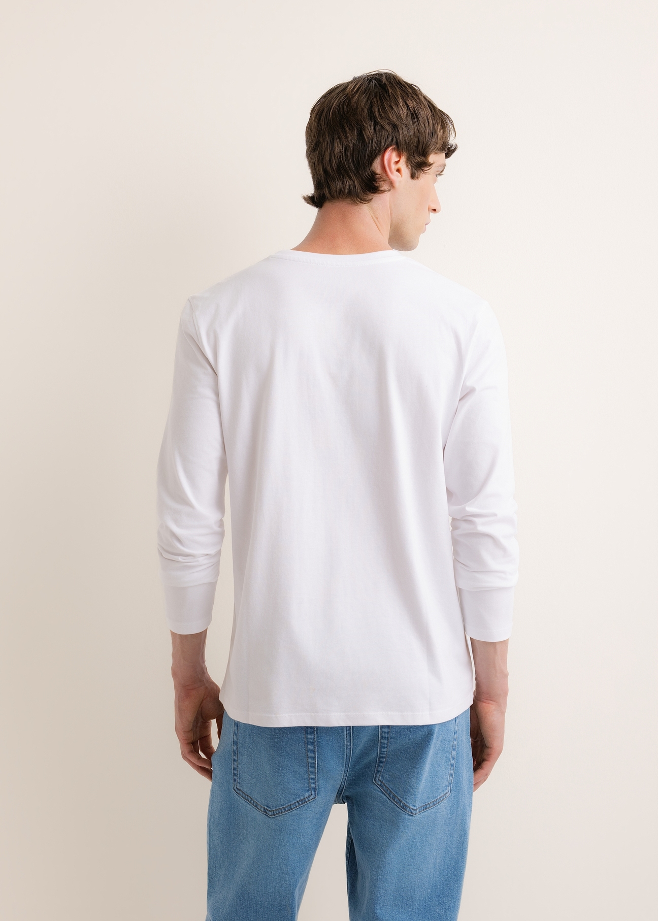 White cotton men's longsleeve LSLMT-0013-0A(Z26), back view of the product on the model. Half of the silhouette visible.