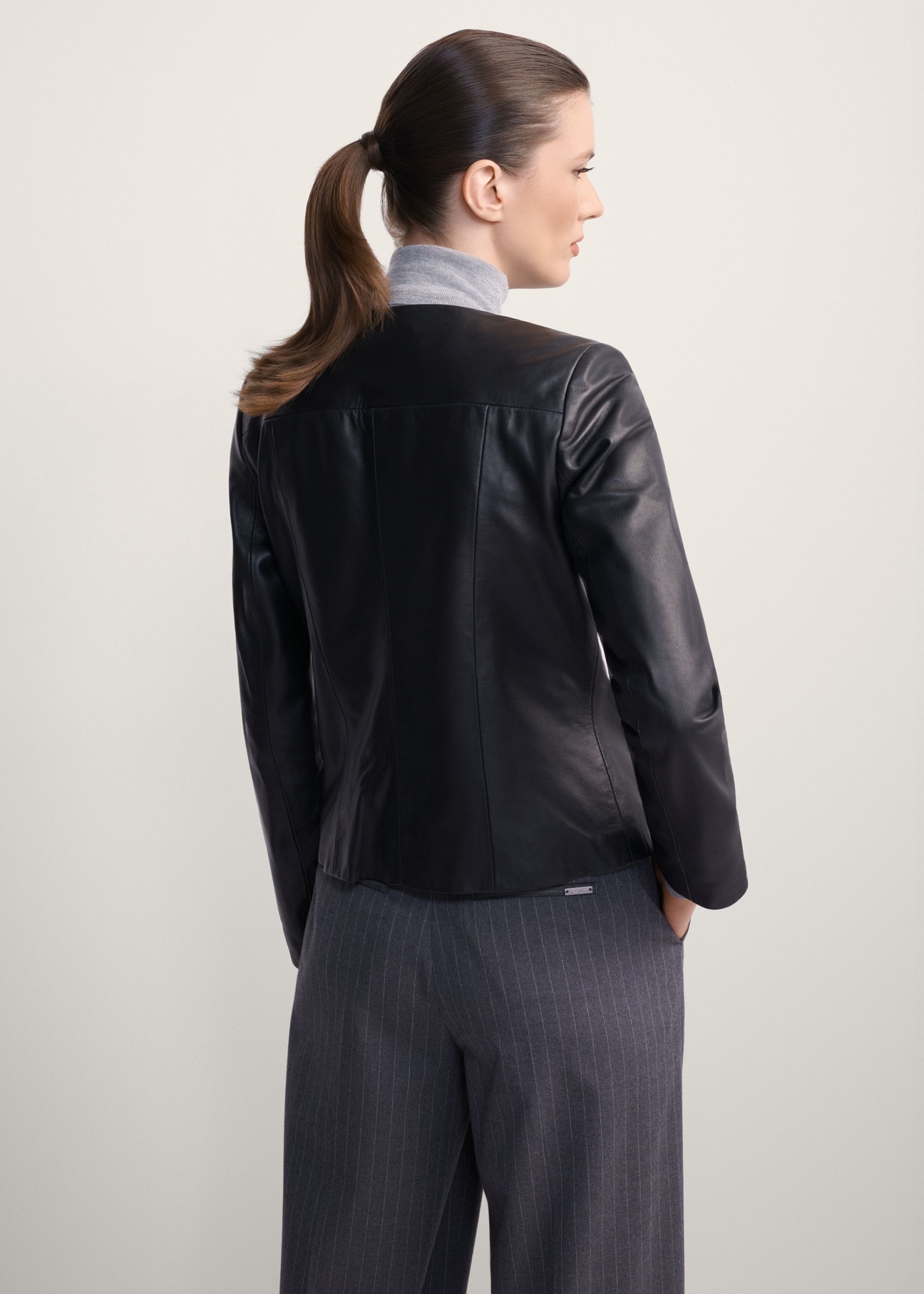 Classic women's genuine leather jacket KURDS-0209-1339(KS), back view of the product on the model. Half of the silhouette visible.