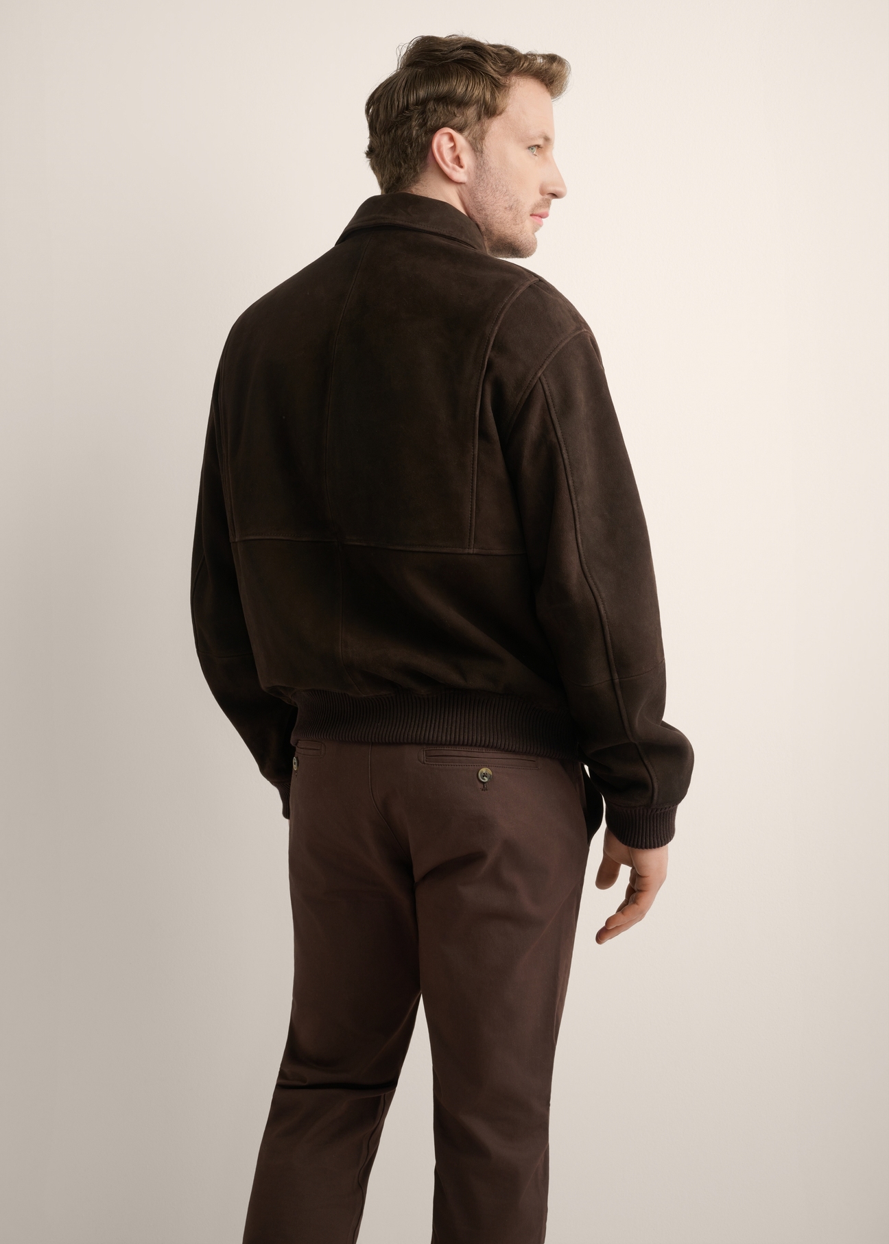 Brown men's suede jacket KURMS-0413-1I(Z26), product view from the back on the model. Half of the silhouette visible.