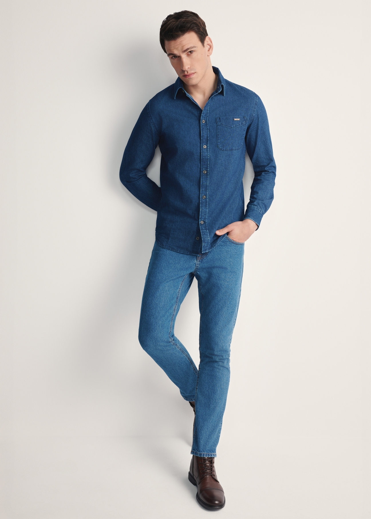 Blue men's denim shirt KOSMT-0348-61(Z25), product visible from the front on the model, the entire silhouette is visible.