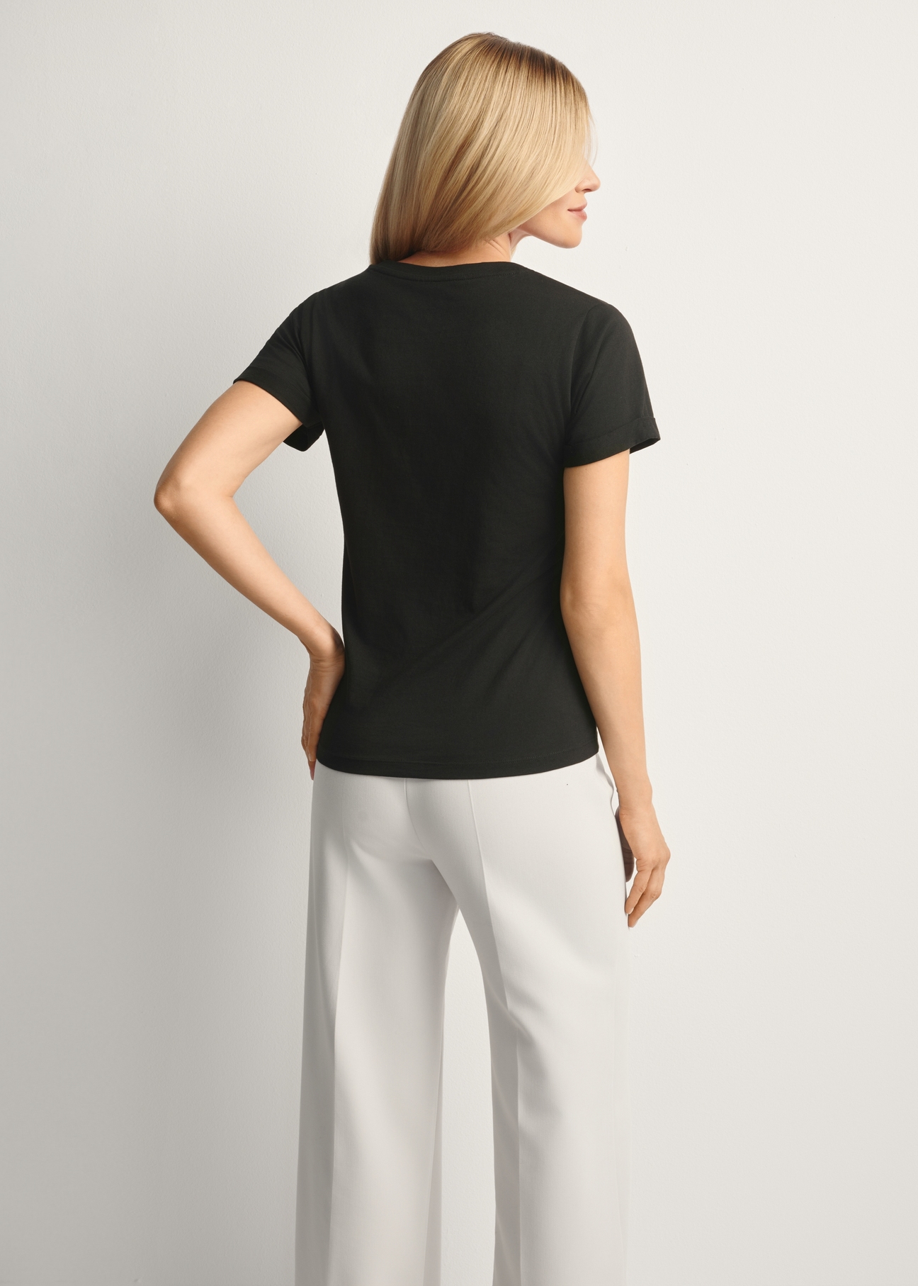 Black women's t-shirt TSHDT-0149-99(Z25), product view from the back on the model, half of the silhouette visible.