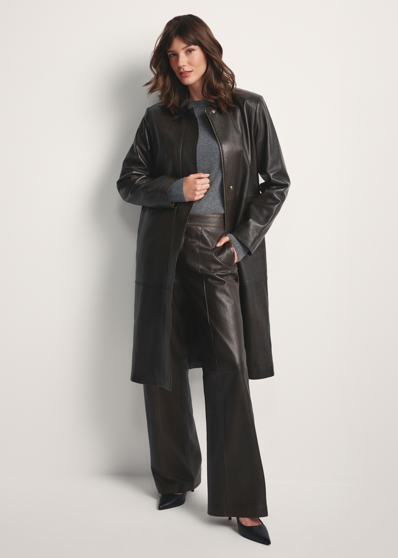 Brown women's long leather jacket KURDS-0544-2868(Z25), front view of the product on the model. Full body visible.