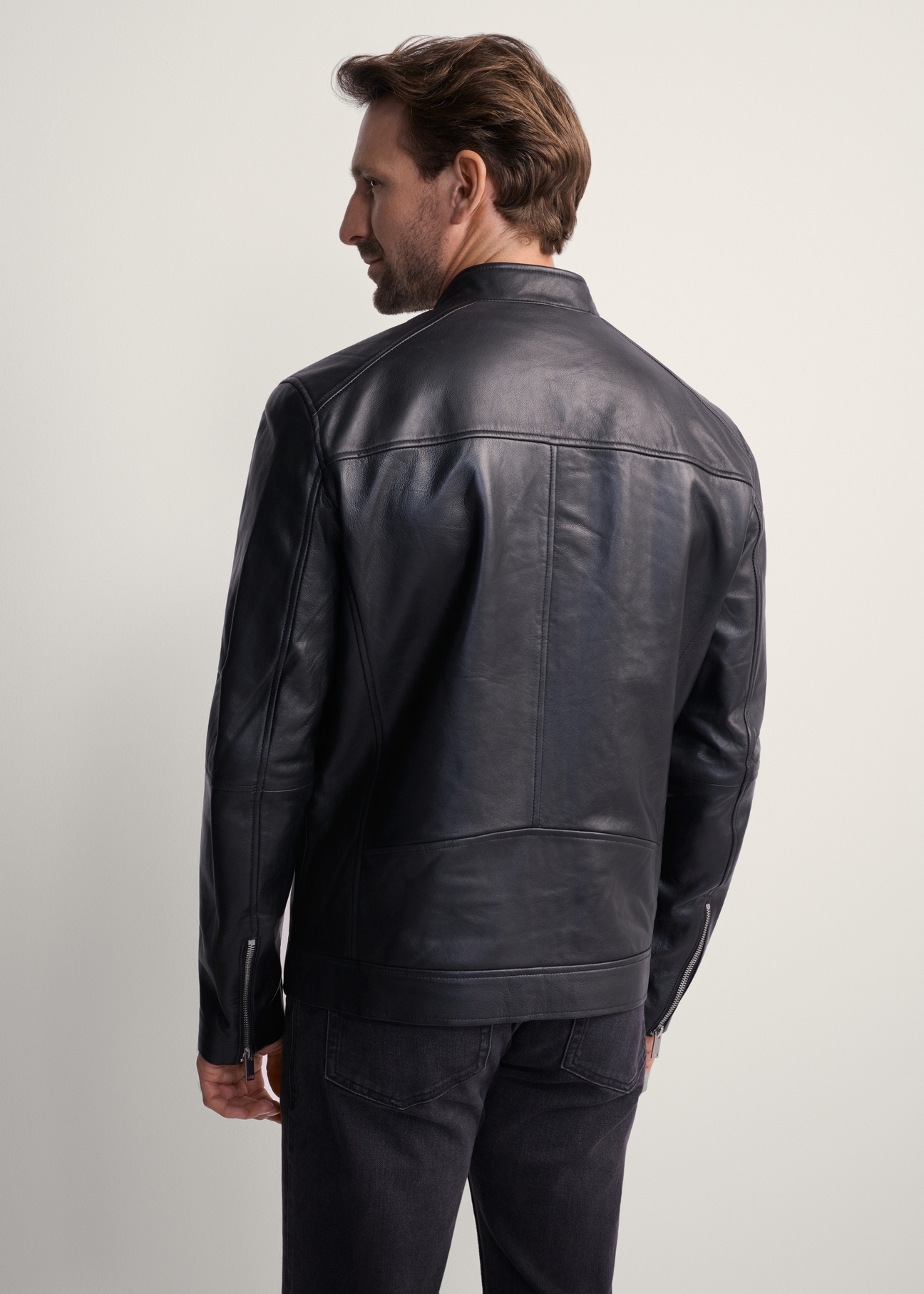 Men's leather jacket with stand-up collar KURMS-0298-1040(KS), product view from the back on the model. Half of the silhouette visible.