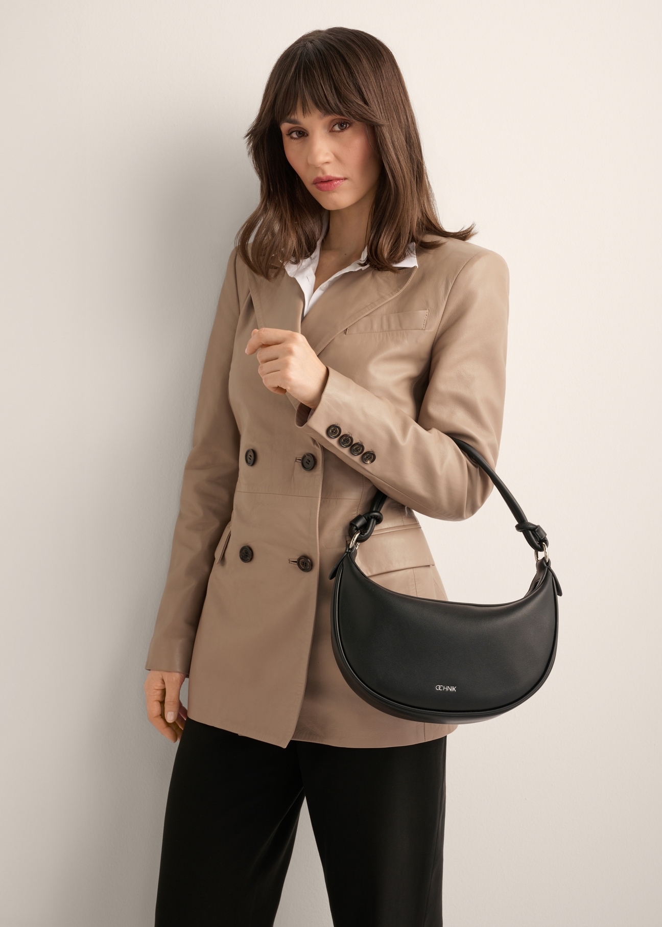 Black small women's hobo bag TOREC-1097-99(Z26), product view on model's shoulder. Half of silhouette visible.