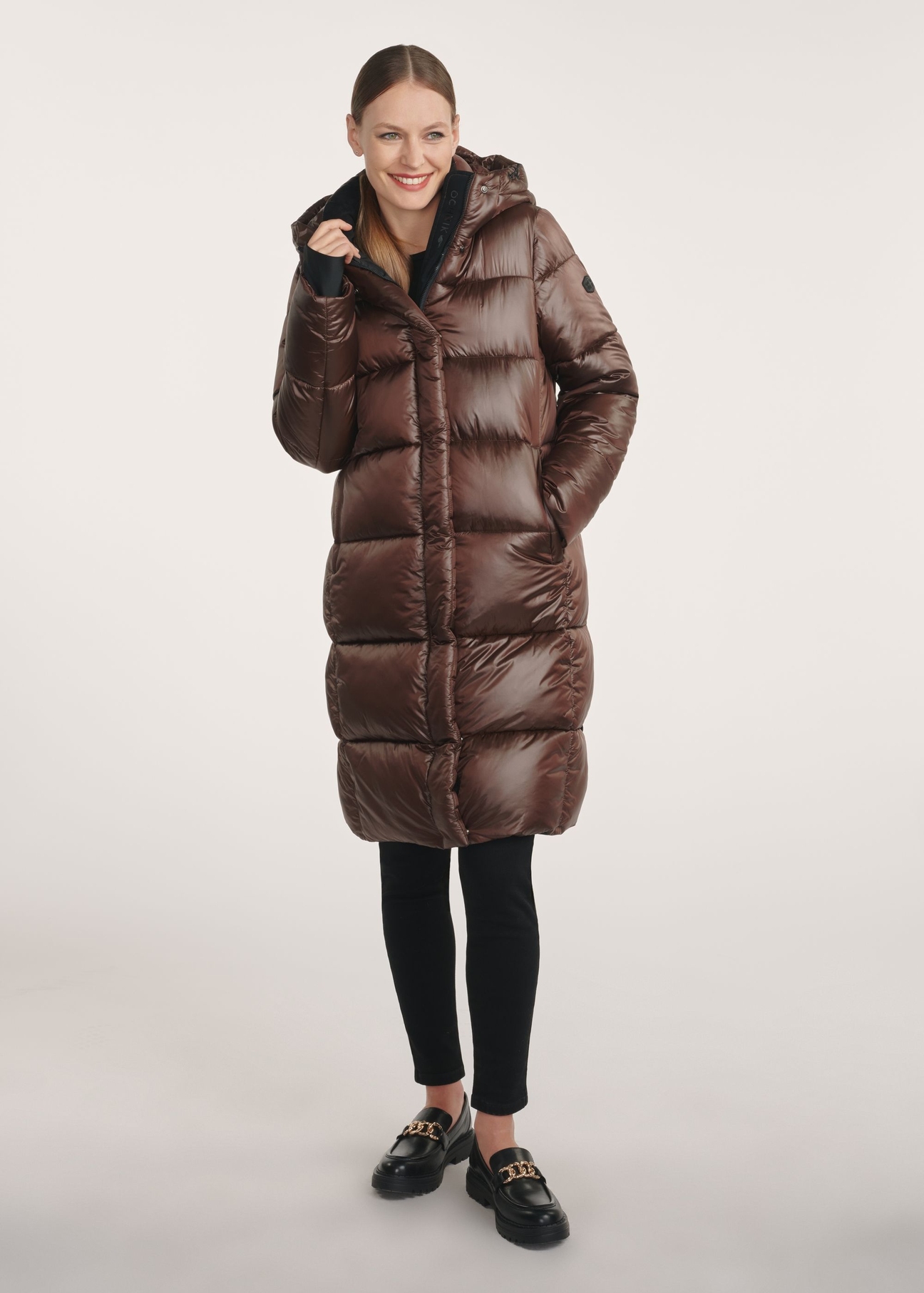 Brown long women's winter jacket KURDT-0531-1H(Z26)- front product view on a model on a white background. The entire silhouette is visible.