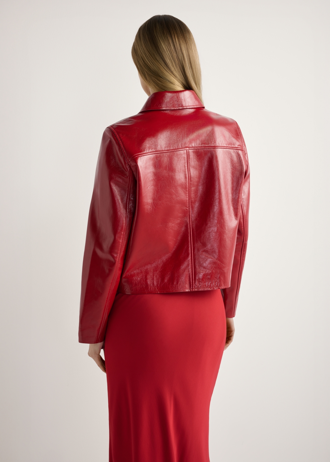 Red short women's jacket KURDS-0612-4B(W26), product view from the back on the model, half of the silhouette visible.