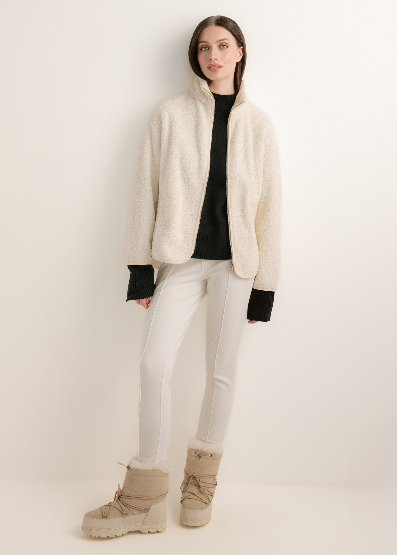 Cream-colored, fitted women's trousers SPODT-0096-0B(Z26); front view of the product on a model. Full-body shot.