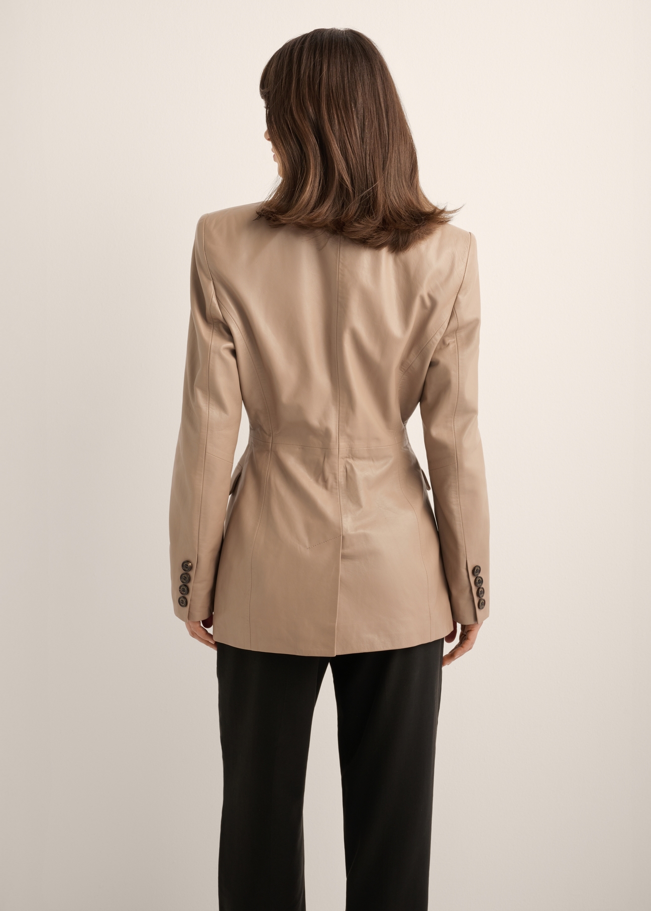 Beige women's leather jacket KURDS-0647-1K(Z26), back view of the product on the model. Half of the silhouette visible.