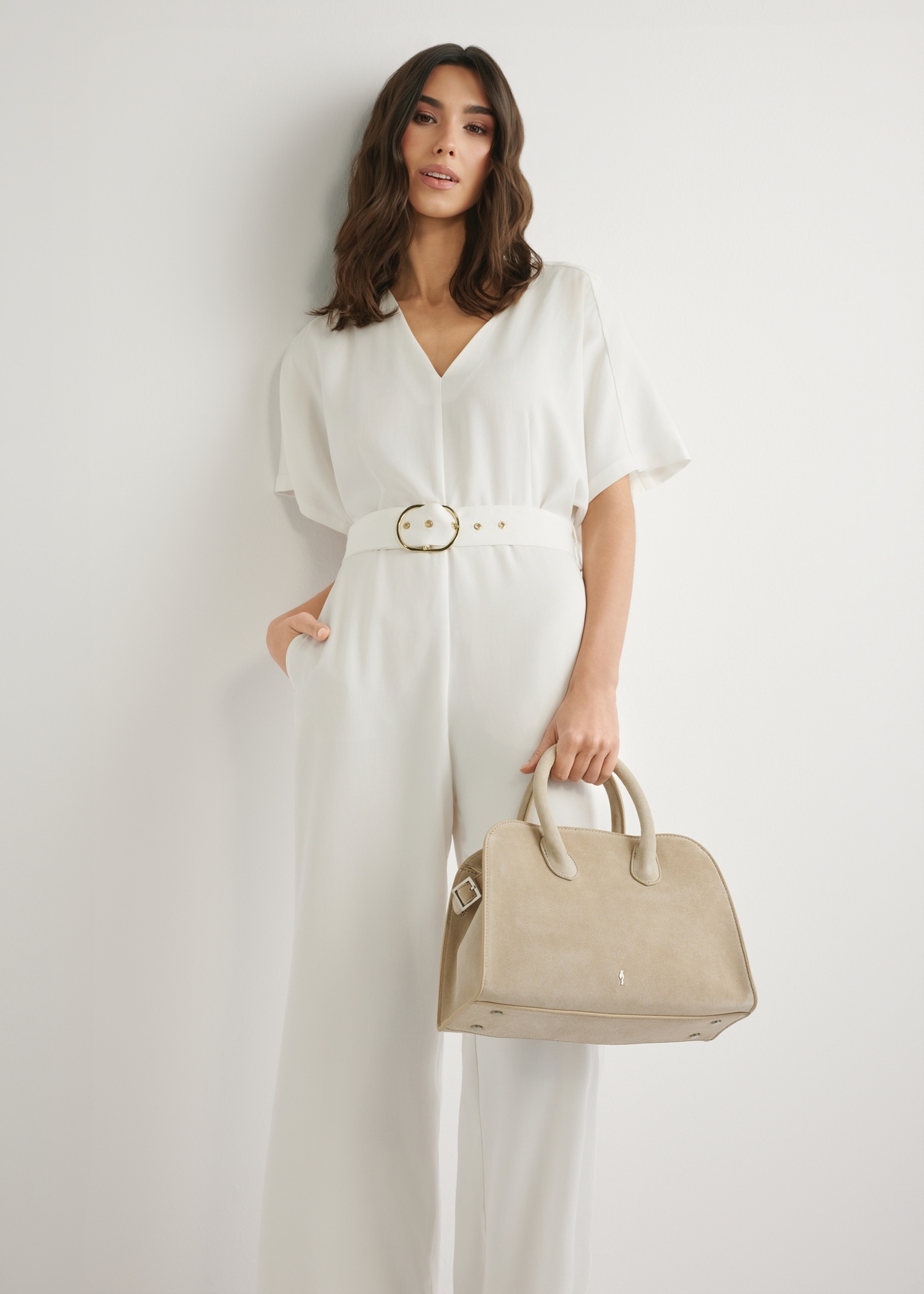 Cream suede women's handbag TORES-1295-0B(W26), product view in model's hand. Half of silhouette visible.