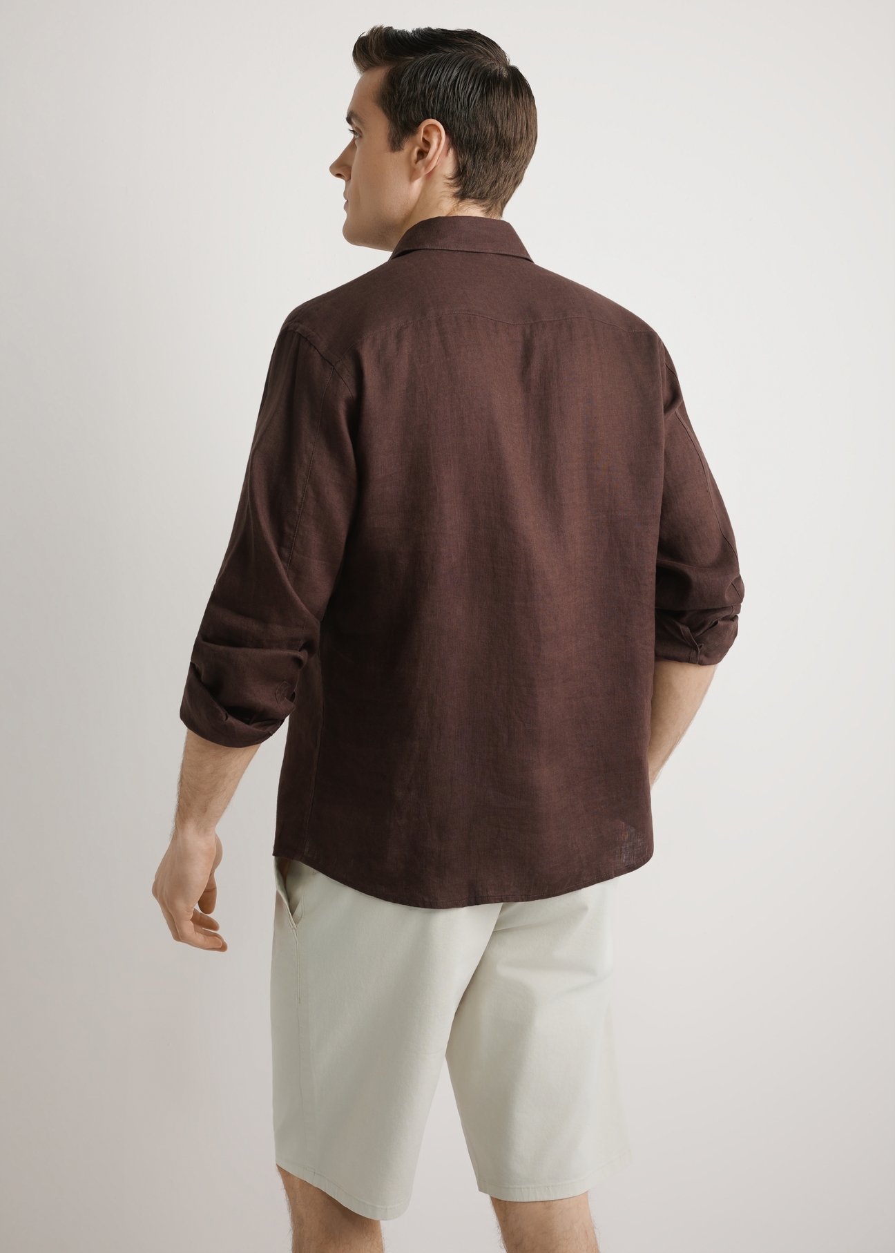 Brown men's linen shirt KOSMT-0321A-1I(W26) - back view of the product, on a model, against a light background. Knee-length silhouette visible.