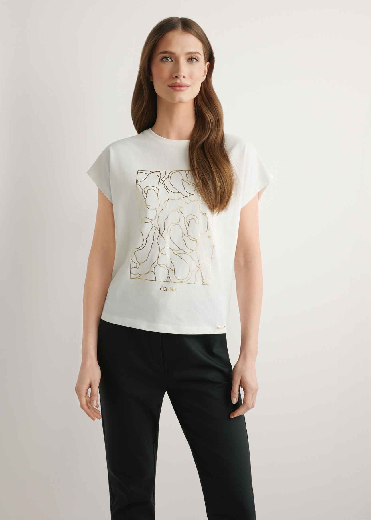 Cream women's T-shirt with gold print TSHDT-0162-0B(W26), front view of the product on the model. Half of the silhouette visible.