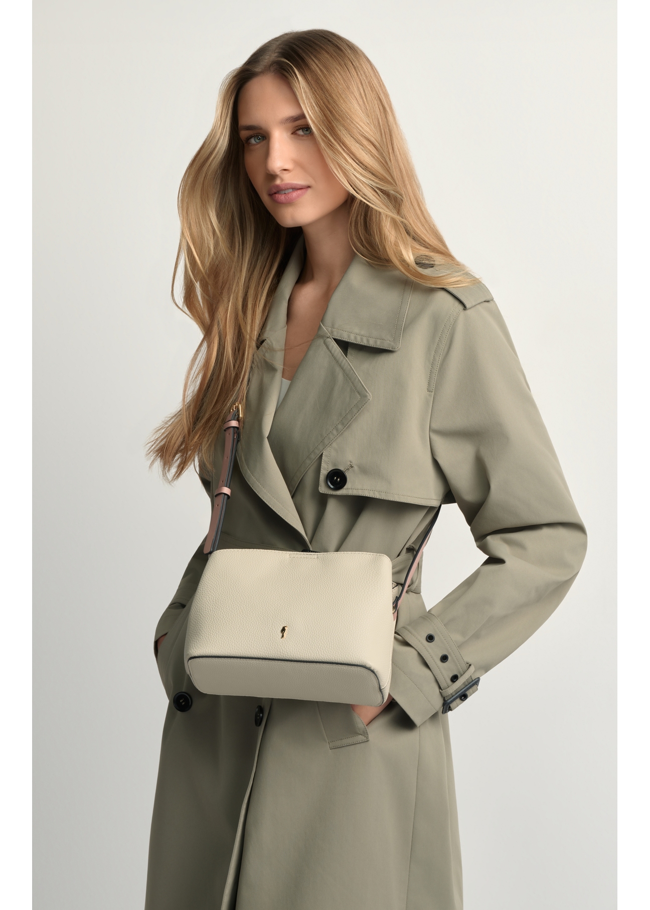 Cream small women's handbag TOREC-0768-0P(W26), product view on model's shoulder. Half of silhouette visible.