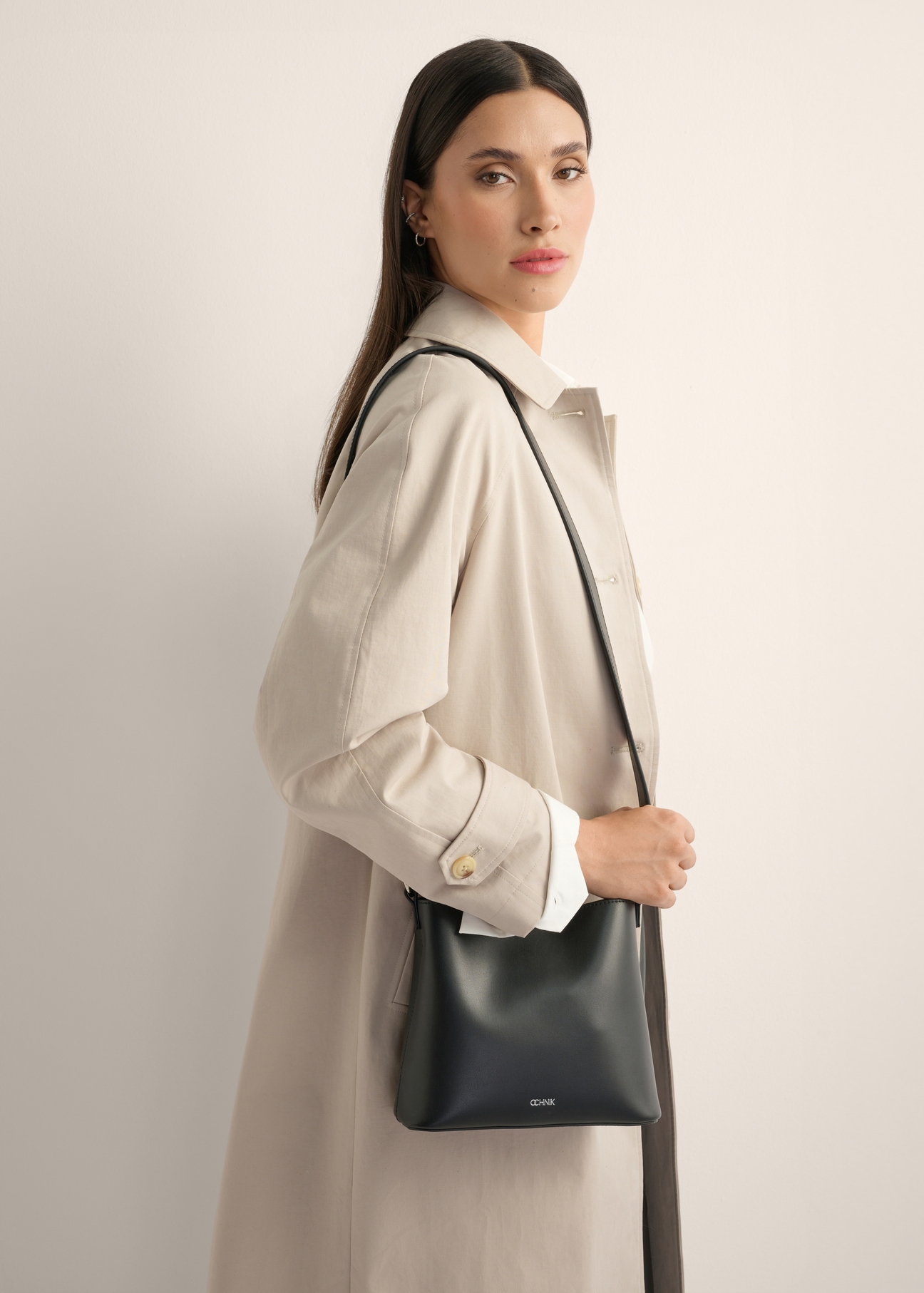 Black small women's handbag TOREC-1336-99(Z26), front view of the product on the model, half of the silhouette visible.