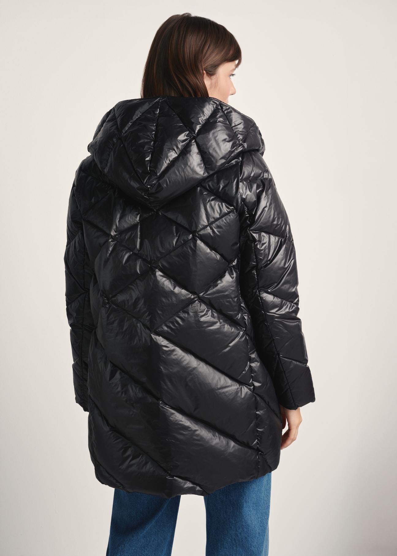 Black women's quilted jacket KURDT-0595-99(Z25), product view from the back on the model, half of the silhouette visible.
