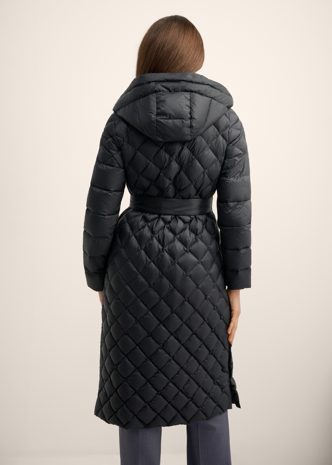 Black women's jacket with natural insulation KURDT-0691-99(Z26), back view of the product on the model. Half of the silhouette visible.