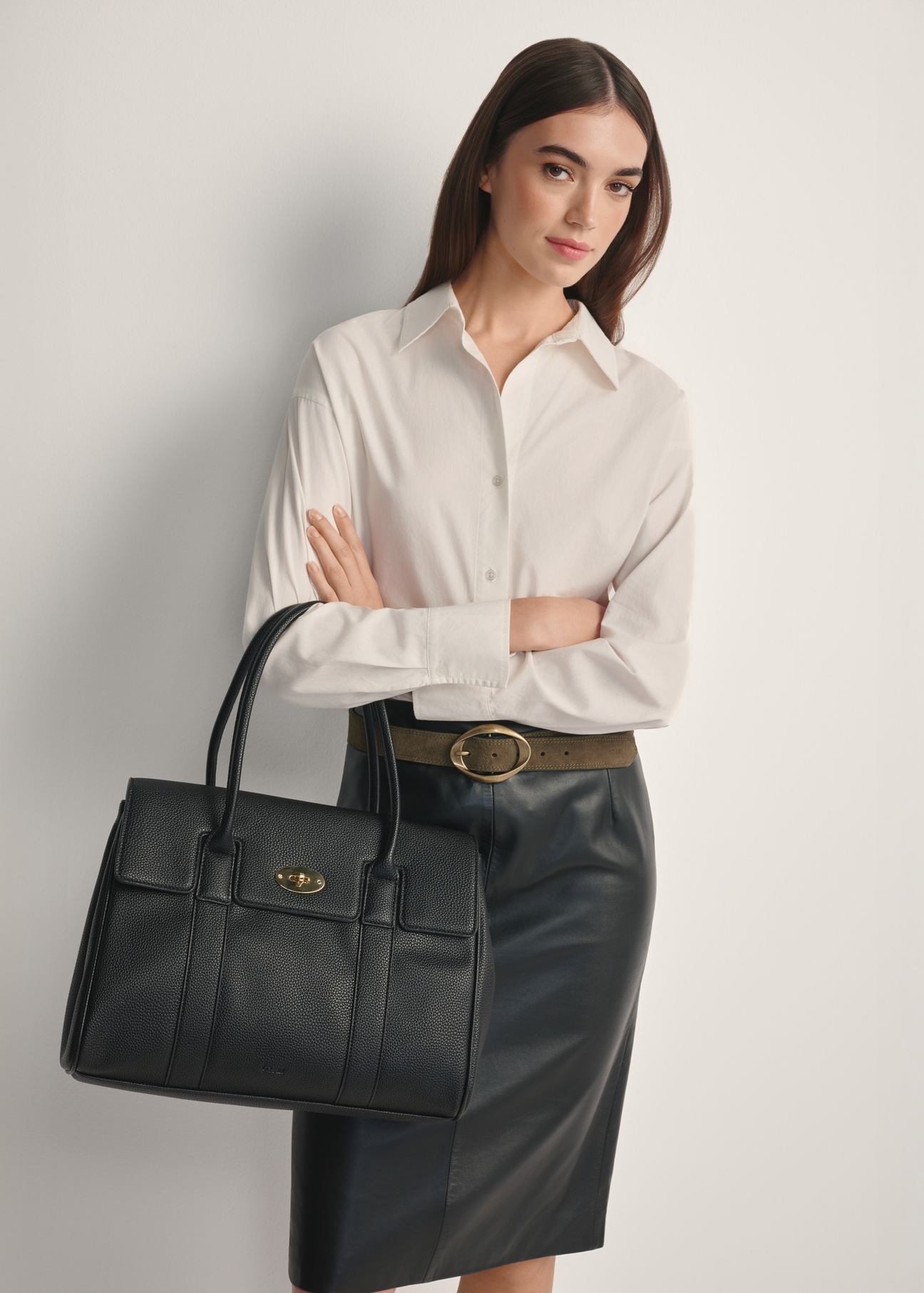 Large black women's handbag TOREC-1139-9I(W26), front view of the product on a model, half of the silhouette visible.