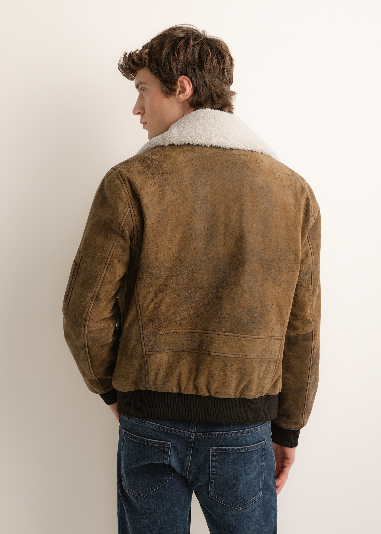 Men's suede bomber jacket KURMS-0422-1C(Z26), product view from the back on the model. Half of the silhouette visible.
