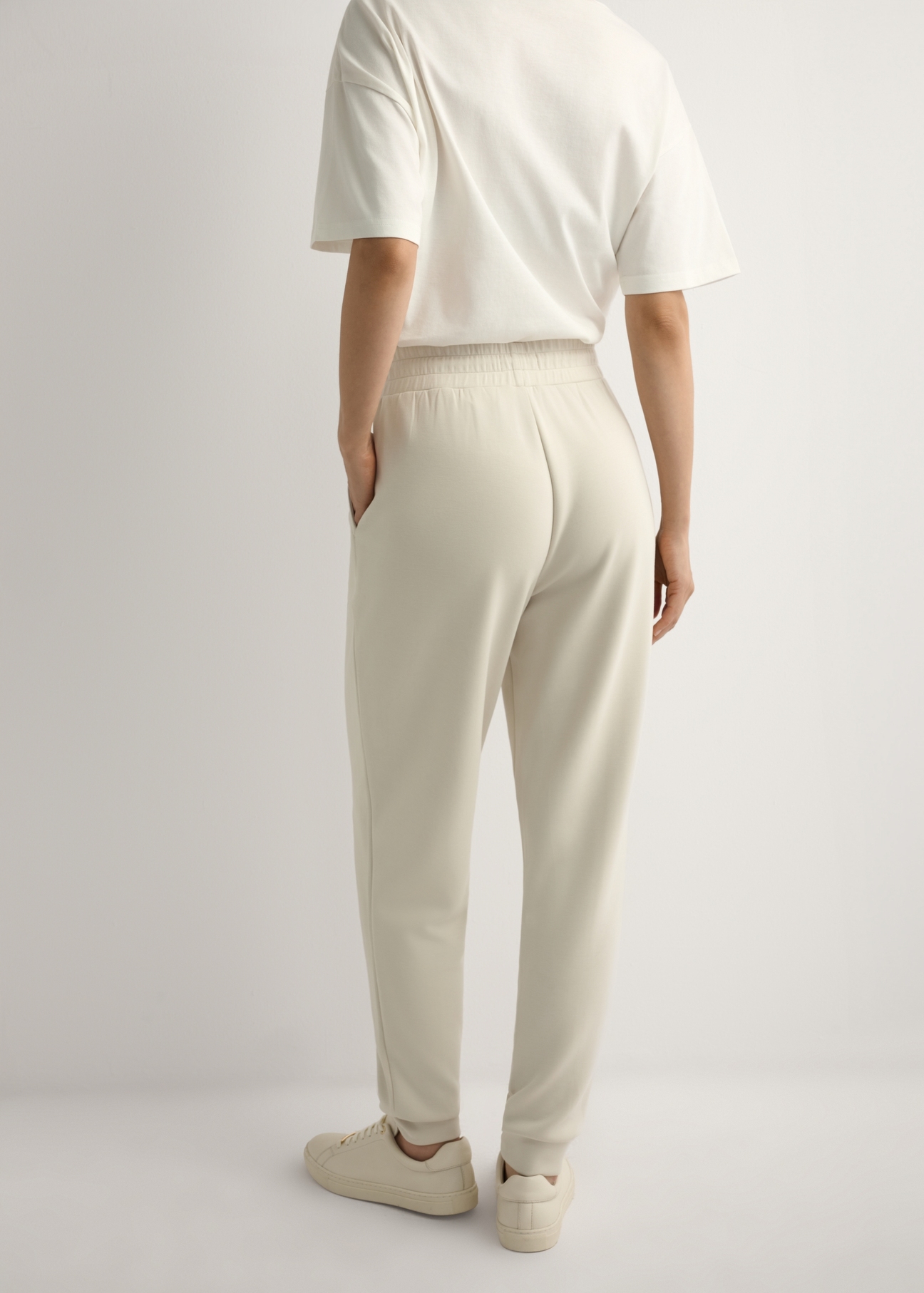 Light beige women's trousers SPODT-0108-1A(W26), back view of the product on the model. Half of the silhouette visible.