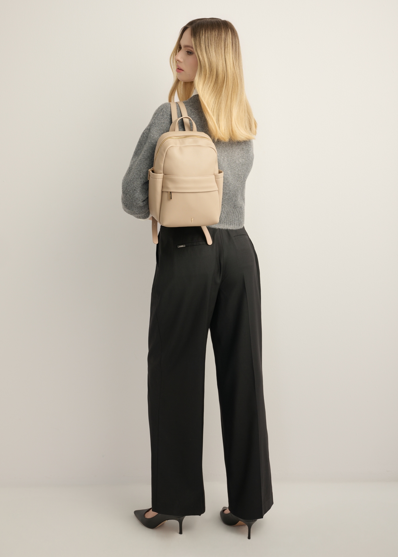 Beige women's imitation leather backpack TOREC-1246-1B(Z26) - front view of the product, on a model, against a light background. Full body visible.