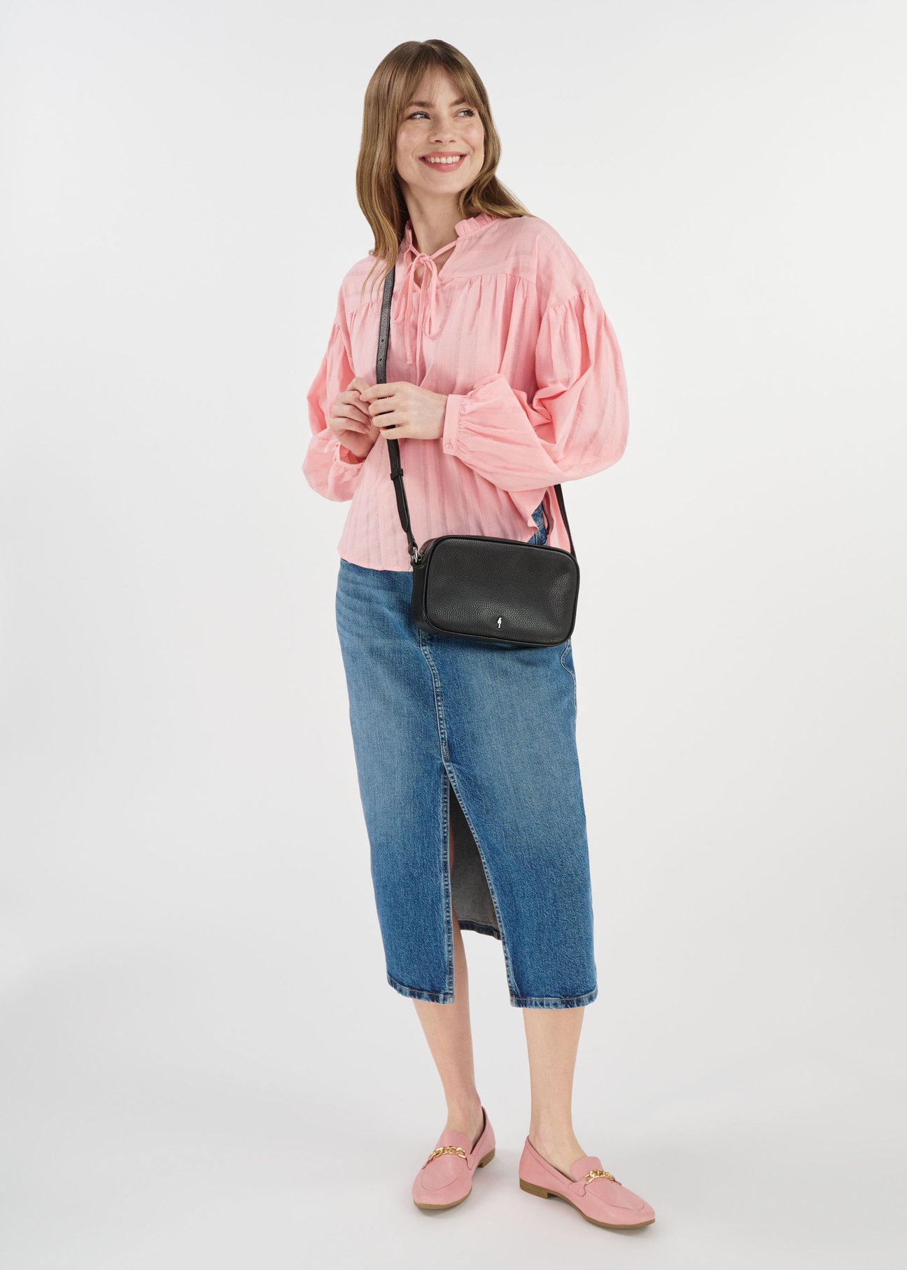 Black leather women's handbag TORES-1103A-99(Z25), front view of the product on a model. The entire silhouette is visible.