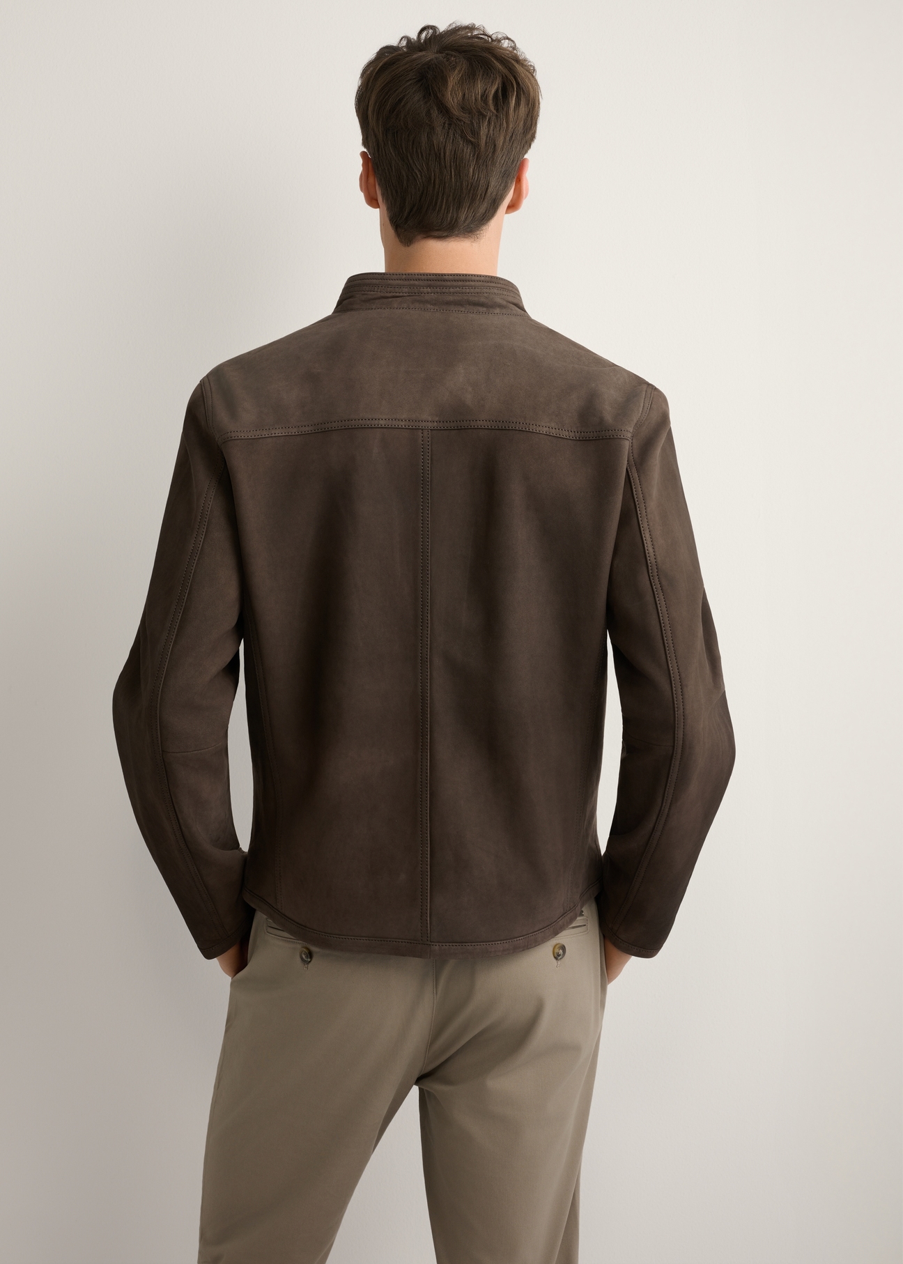 Brown men's suede jacket KURMS-0396-1I(W26) - back view of the product, on a model, against a light background. Half of the silhouette visible.