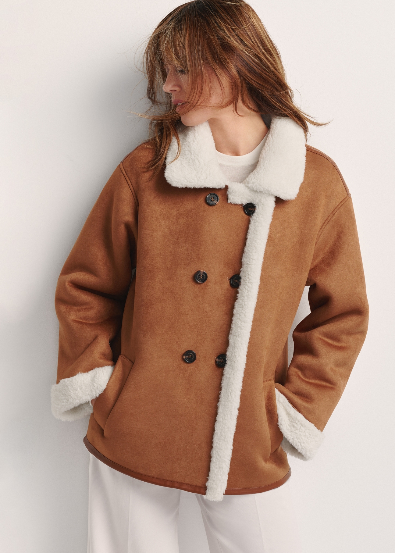 Women's sheepskin coat in camel color KOZDP-0013-24(Z25) - front view of the product on a model on a white background. Half of the silhouette visible.