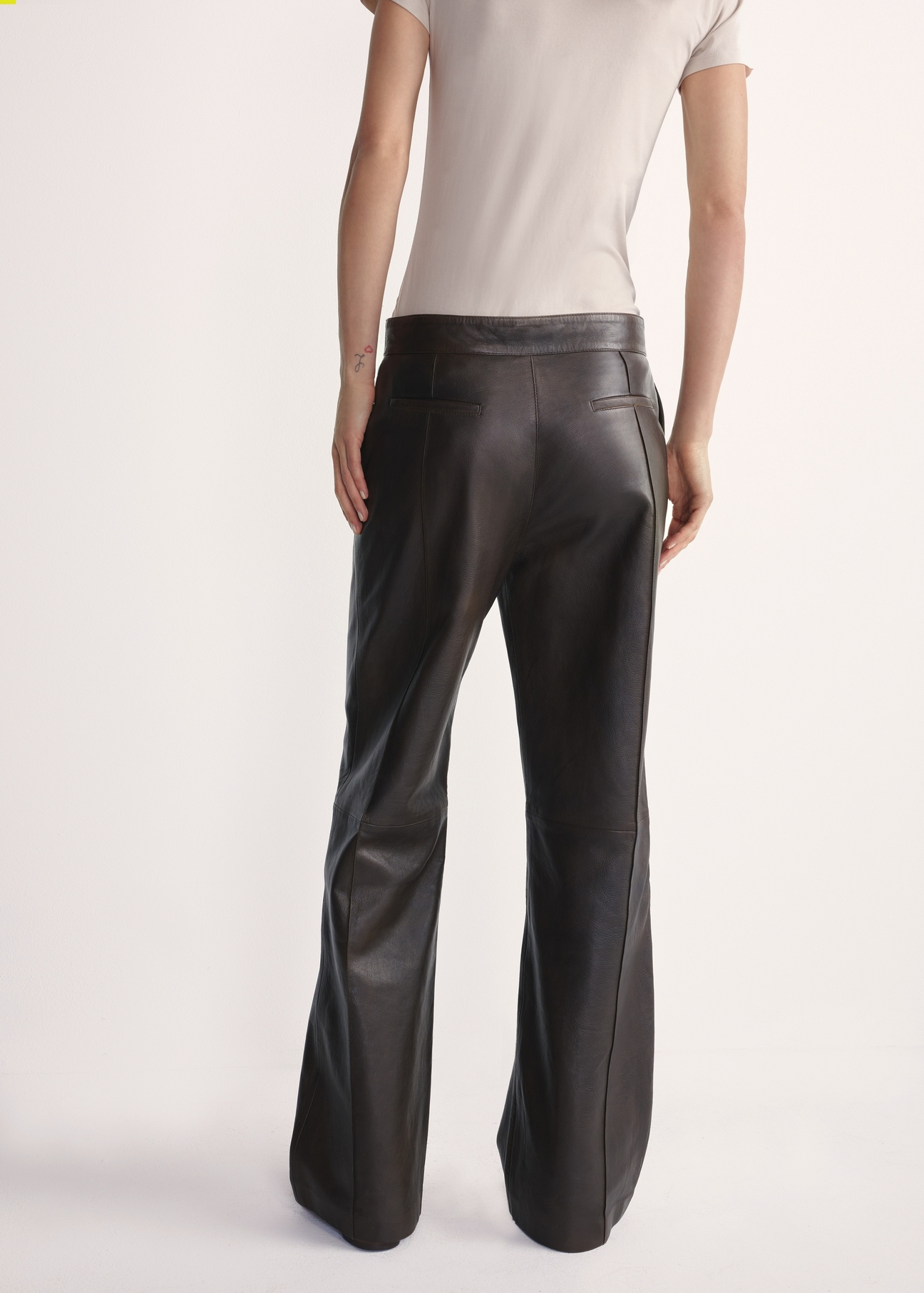 Women's brown leather trousers SPODS-0045-3207(Z25), product visible from the back on the model, half of the silhouette visible.