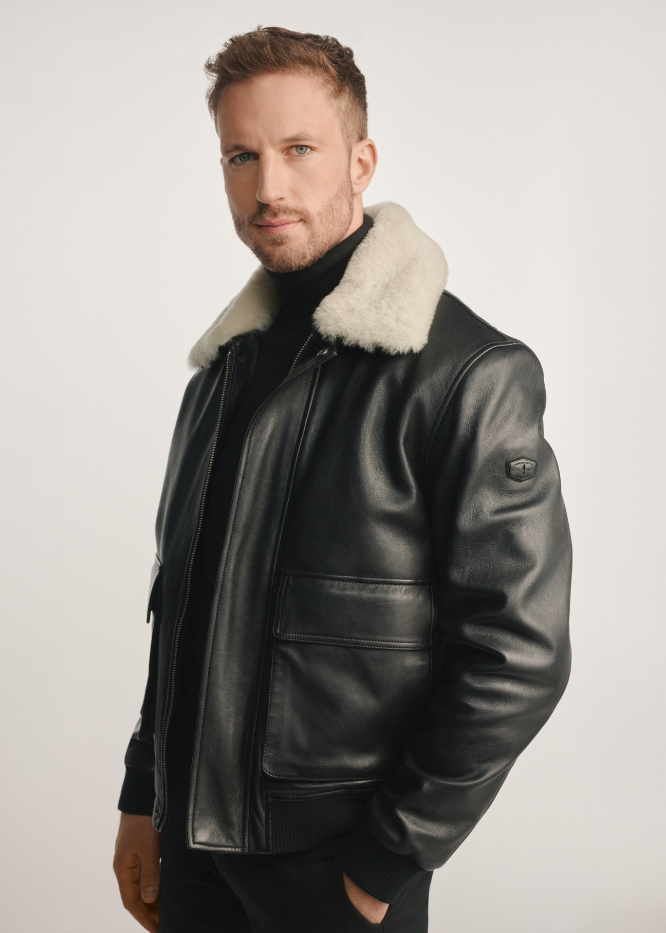 Black men's leather pilot jacket KURMS-0378-2745(Z25), side view of the product on the model, half of the silhouette visible.