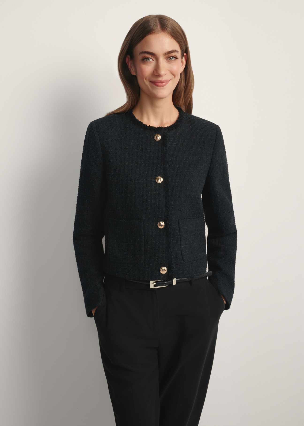 Women's black short blazer ZAKDT-0041-99(W26), front view of the product on the model. Half of the silhouette visible.
