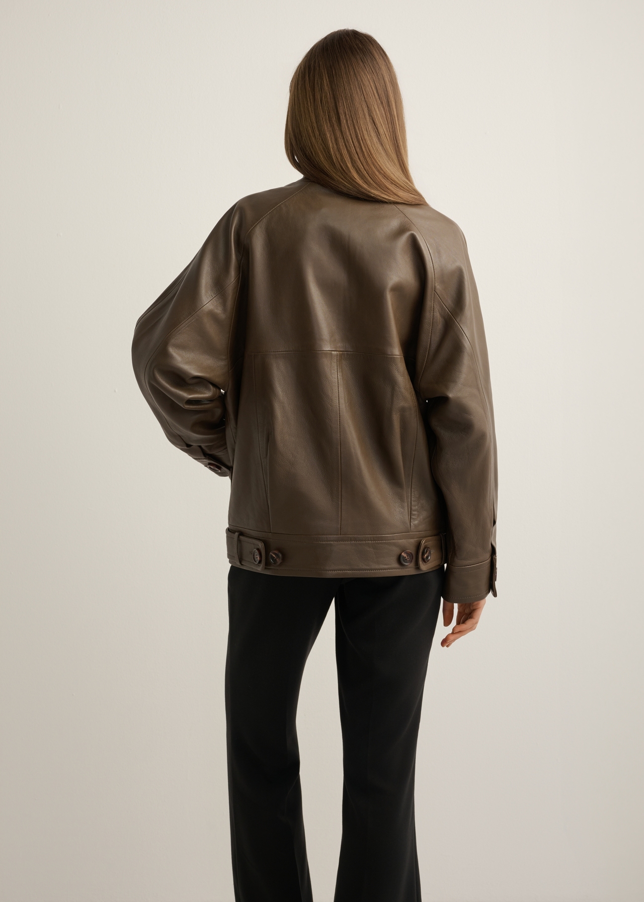 Women's oversize brown leather jacket KURDS-0592-1K(Z26), product view from the back on the model, half of the silhouette visible.