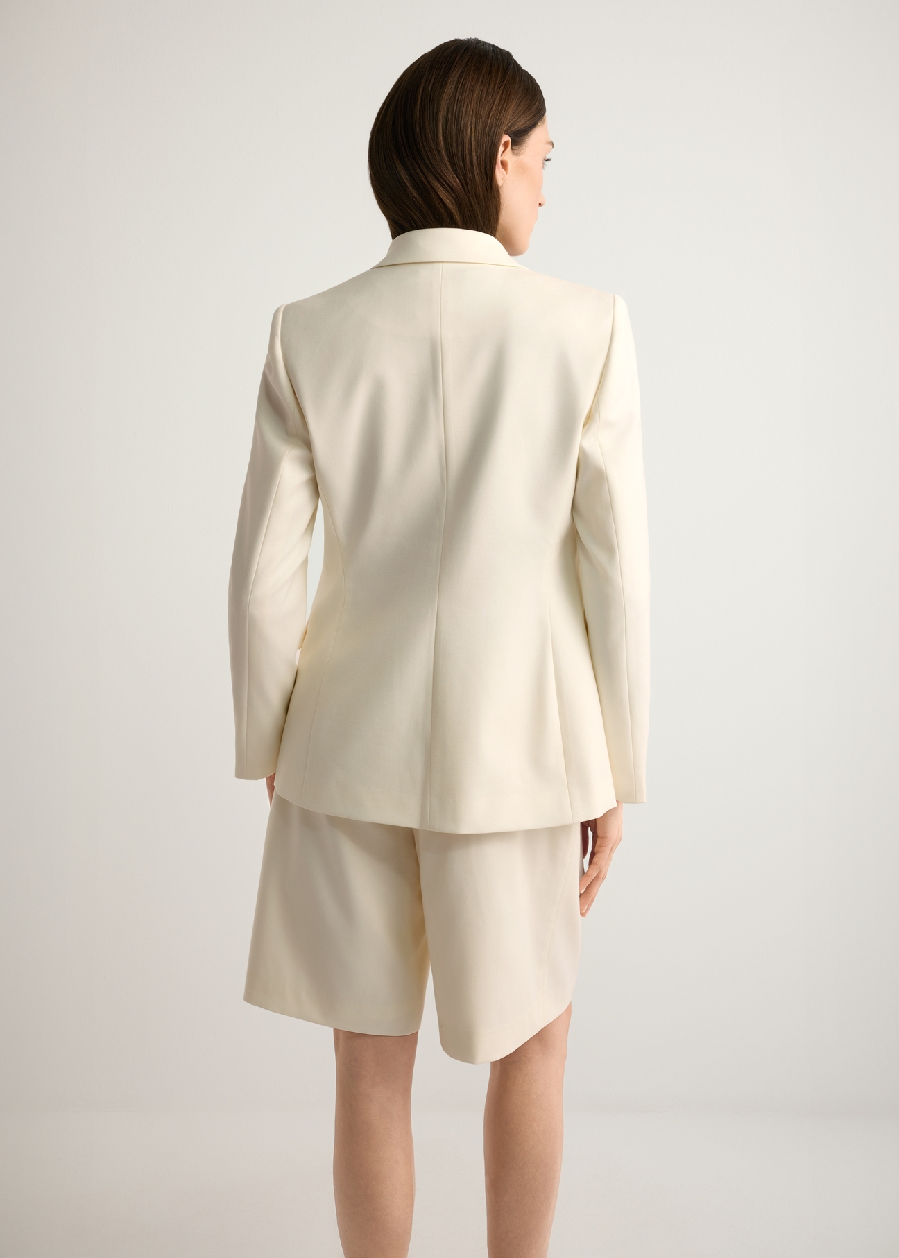 Women's white wool-blend blazer ZAKDT-0045-0B(W26), back view of the product on the model. Half of the silhouette visible.