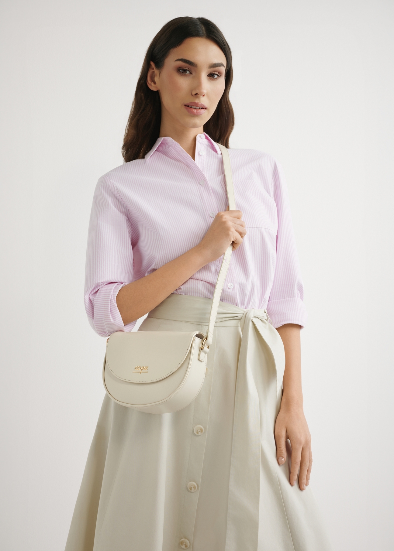 Cream leather small handbag TORES-1260-0B(W26), product view on model's shoulder. Half of silhouette visible.