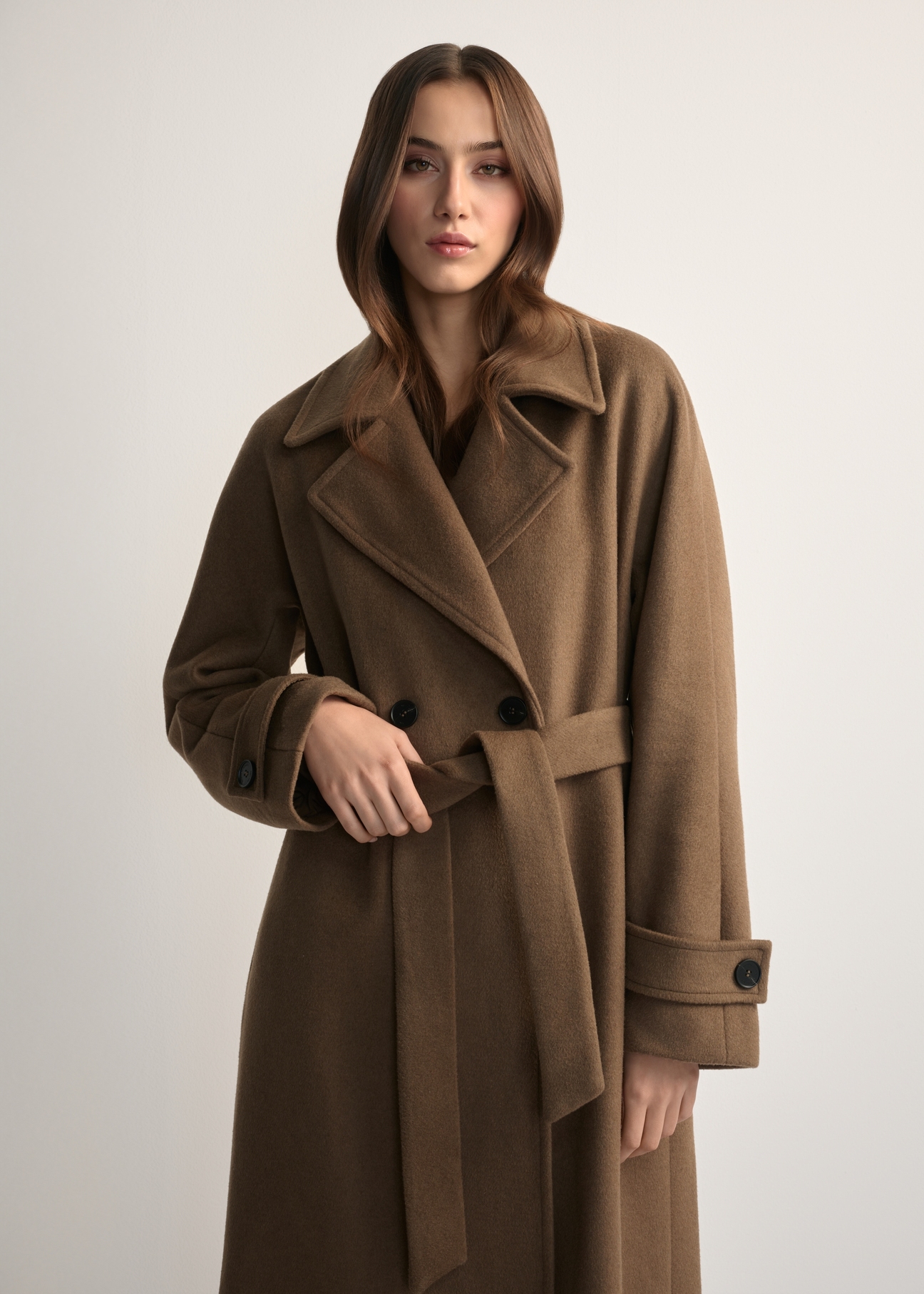 Women's wool coat camel PLADT-0061-24(Z25) - front view of the product, on a model, against a light background. Half of the silhouette visible.