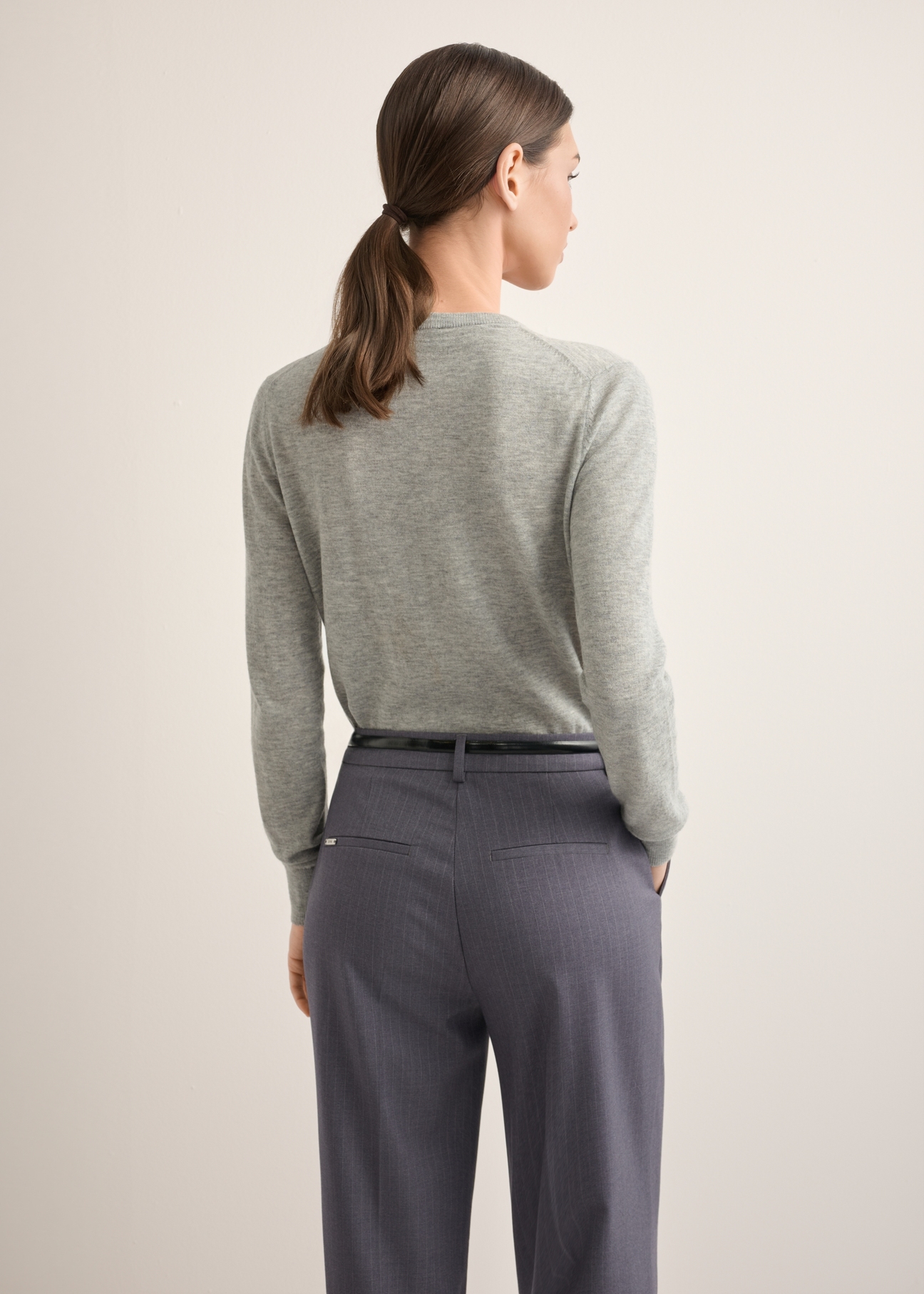 Women's wool cardigan in gray KARDT-0065-9B(Z26), back view of the product on the model. Half of the silhouette visible.