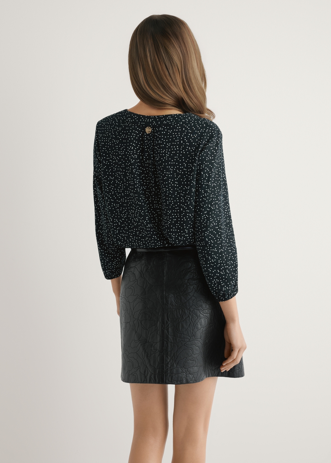 Women's polka dot blouse BLUDT-0172A-9P(W26) - back view of the product, on a model, against a light background. Half of the silhouette visible.