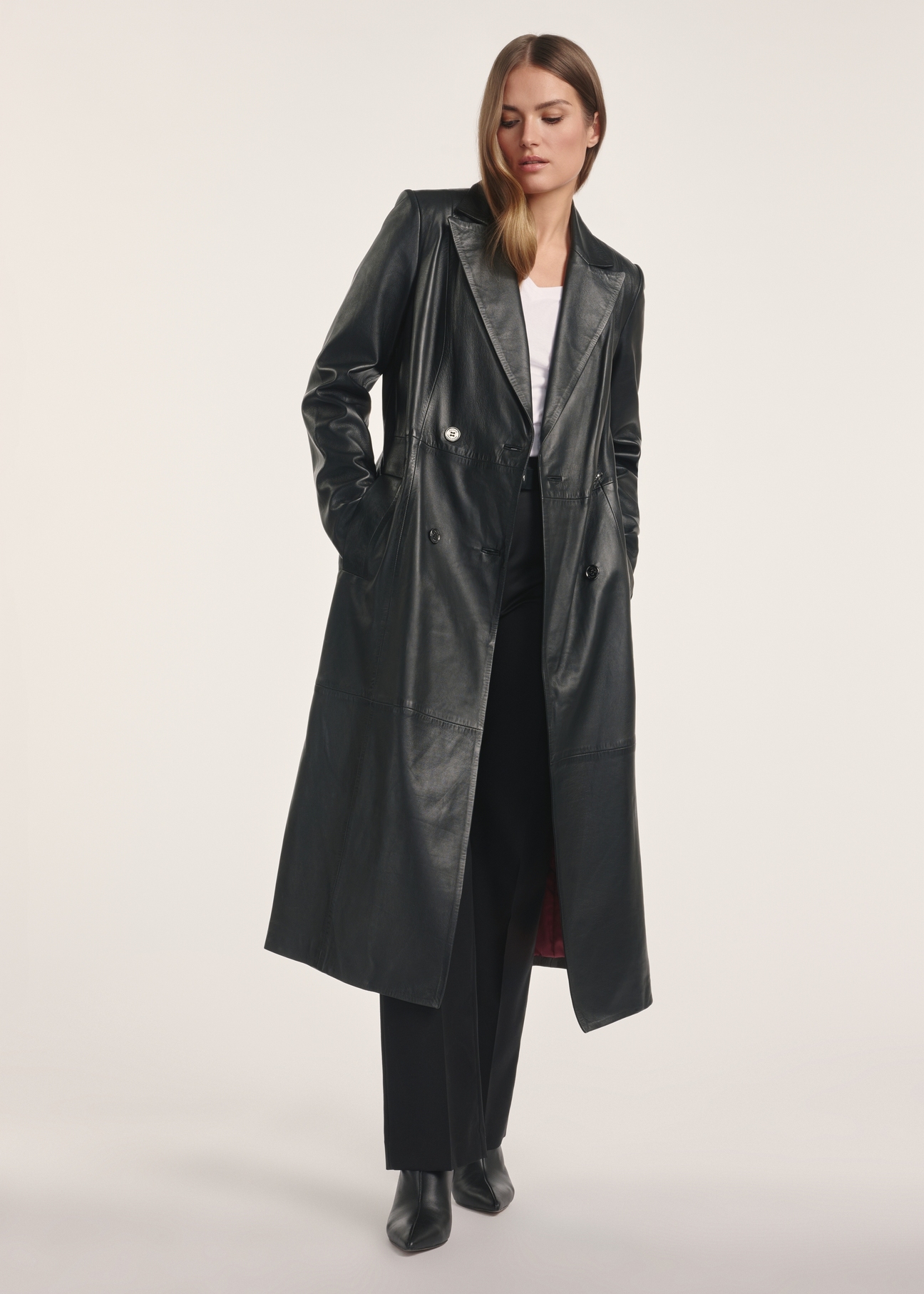 Black women's leather coat KURDS-0546-5344(Z25), product visible from the front on the model, the entire silhouette is visible.