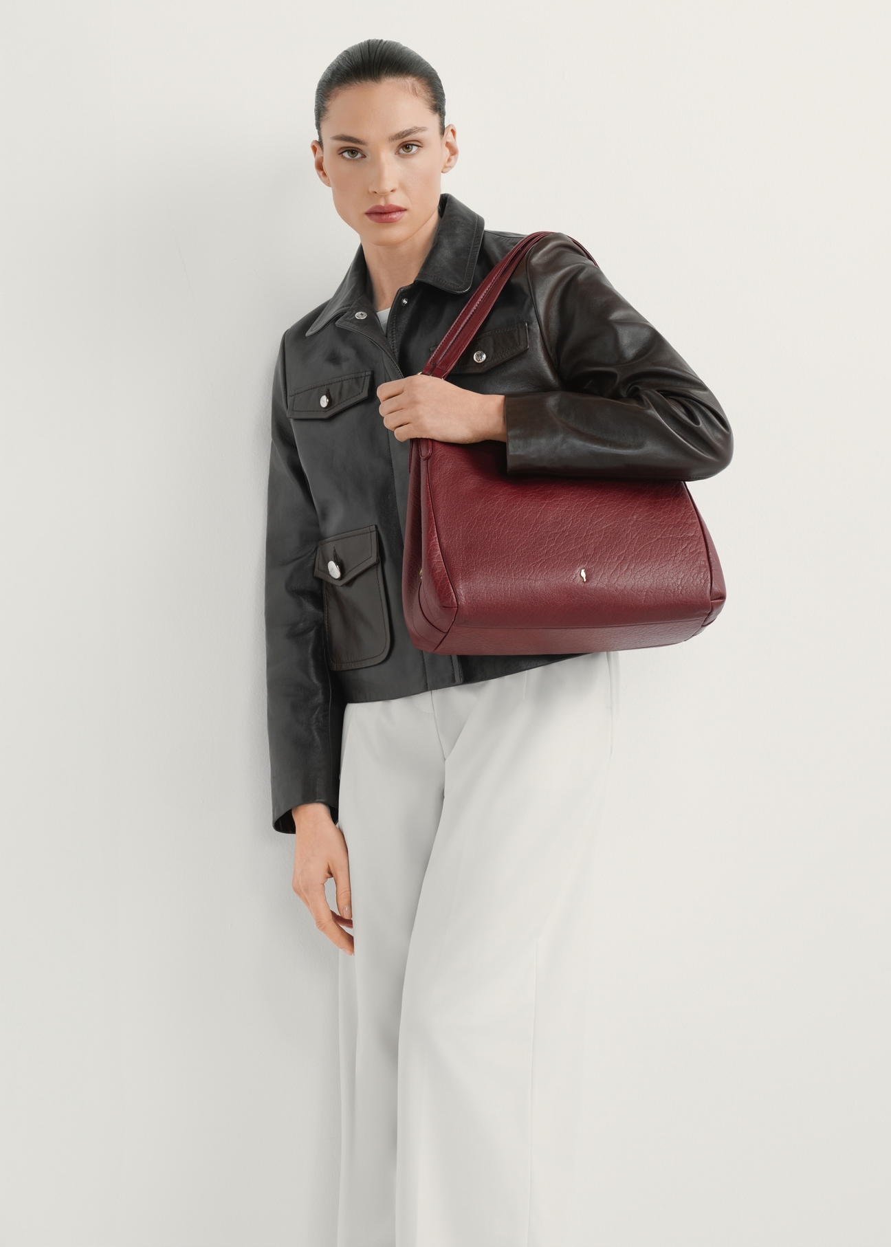 Dark red leather women's shopper bag TORES-0636D-4C(W26) - product view slightly diagonal, on a model, against a light background. The entire silhouette is visible.