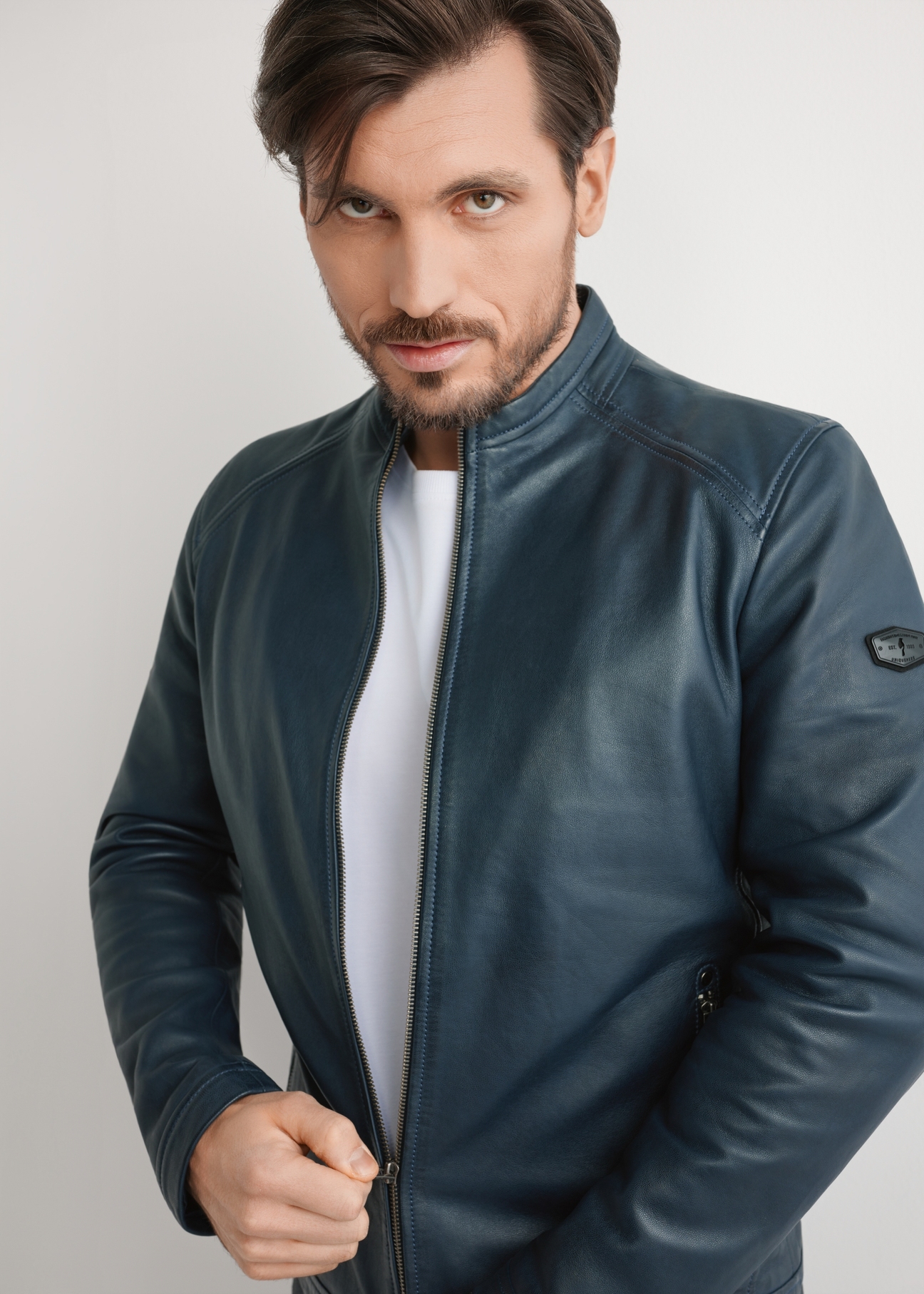 Navy blue men's leather jacket KURMS-0329-7E(W26) - front view of the product on a model, against a light background. Half of the silhouette visible.