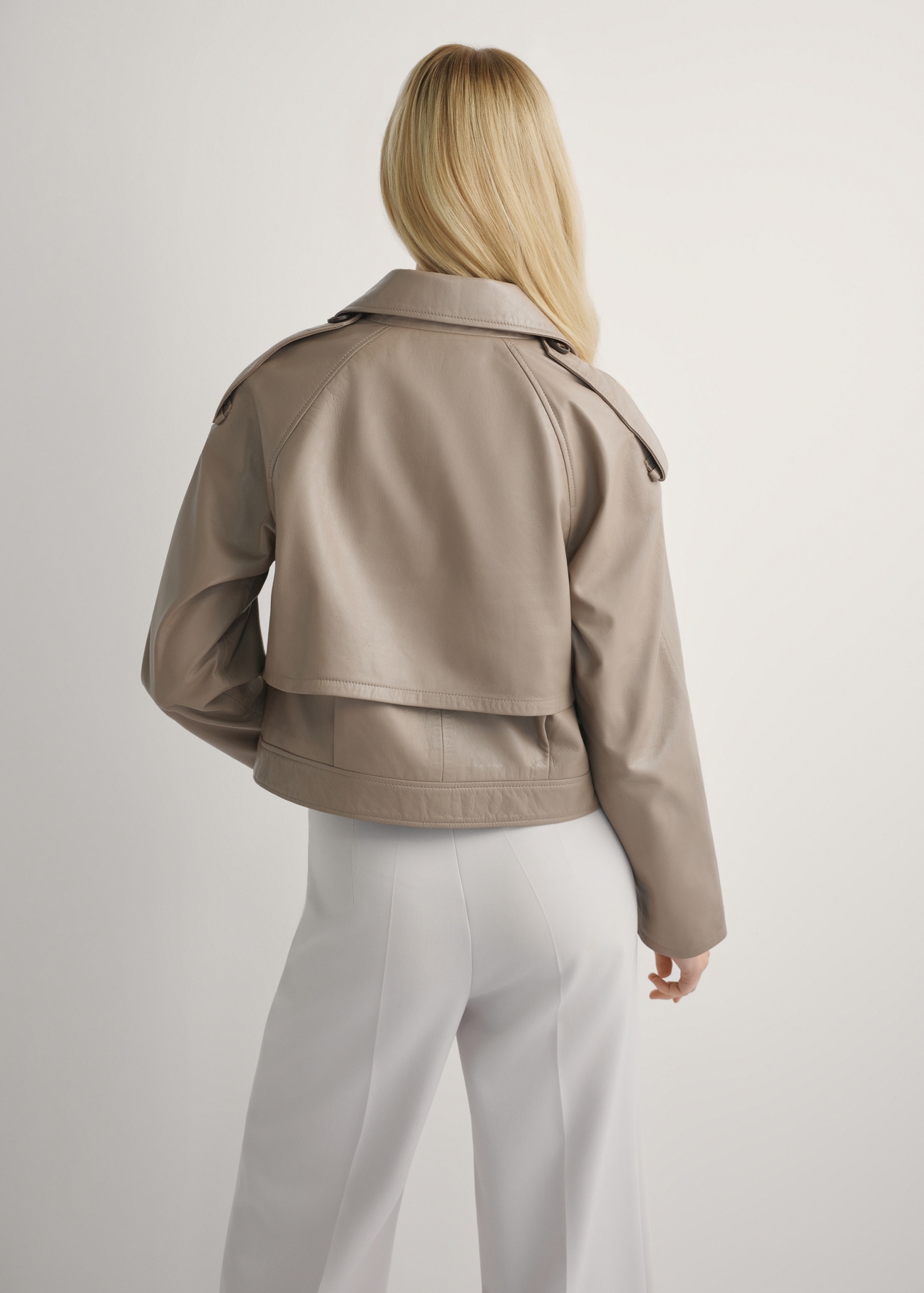 Beige oversized women's leather jacket KURDS-0511A-1K(W26), back view of the product on the model. Half of the silhouette visible.