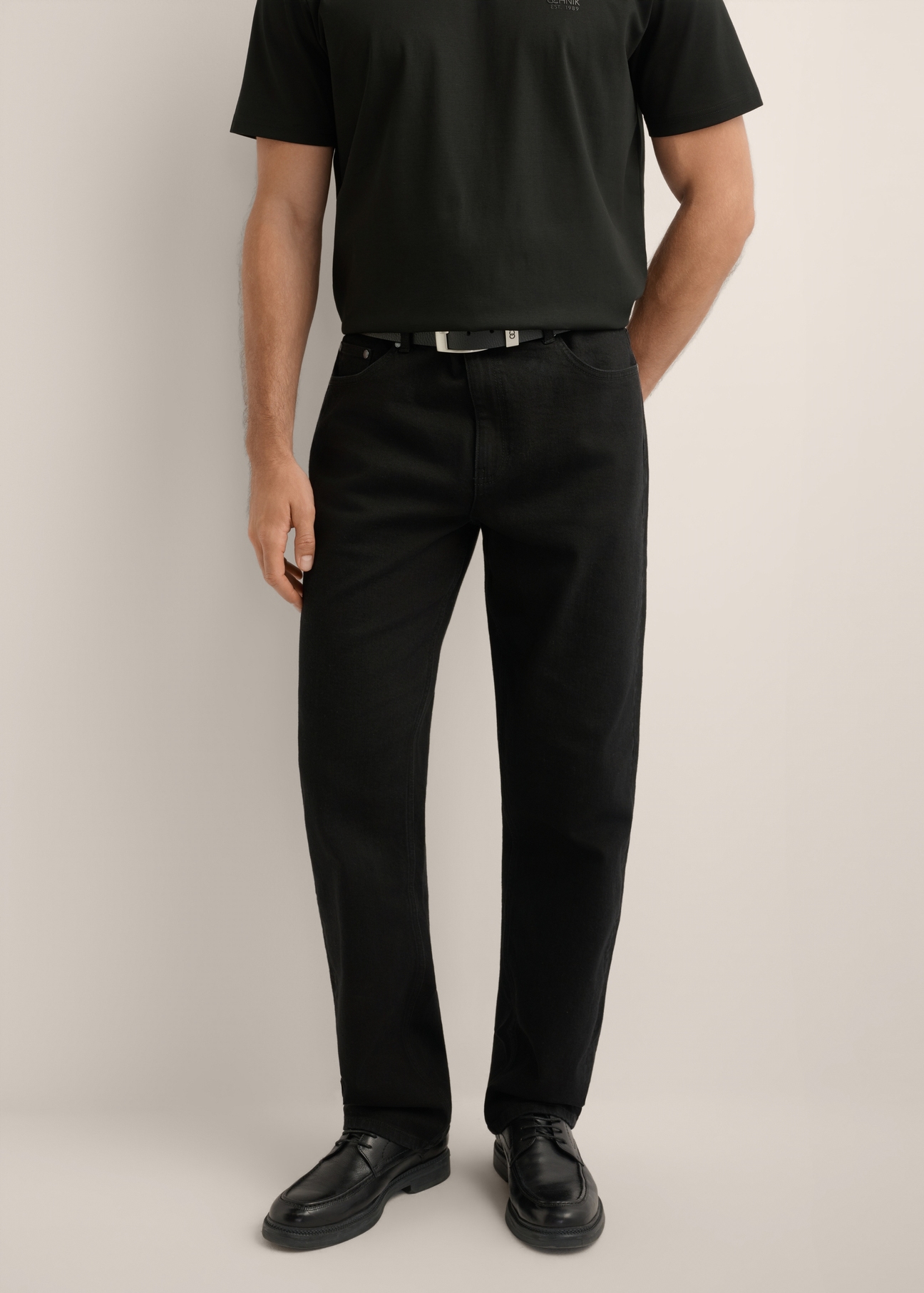 Men's black jeans JEAMT-0025-99(Z26), front view of the product on the model. Half of the silhouette visible.