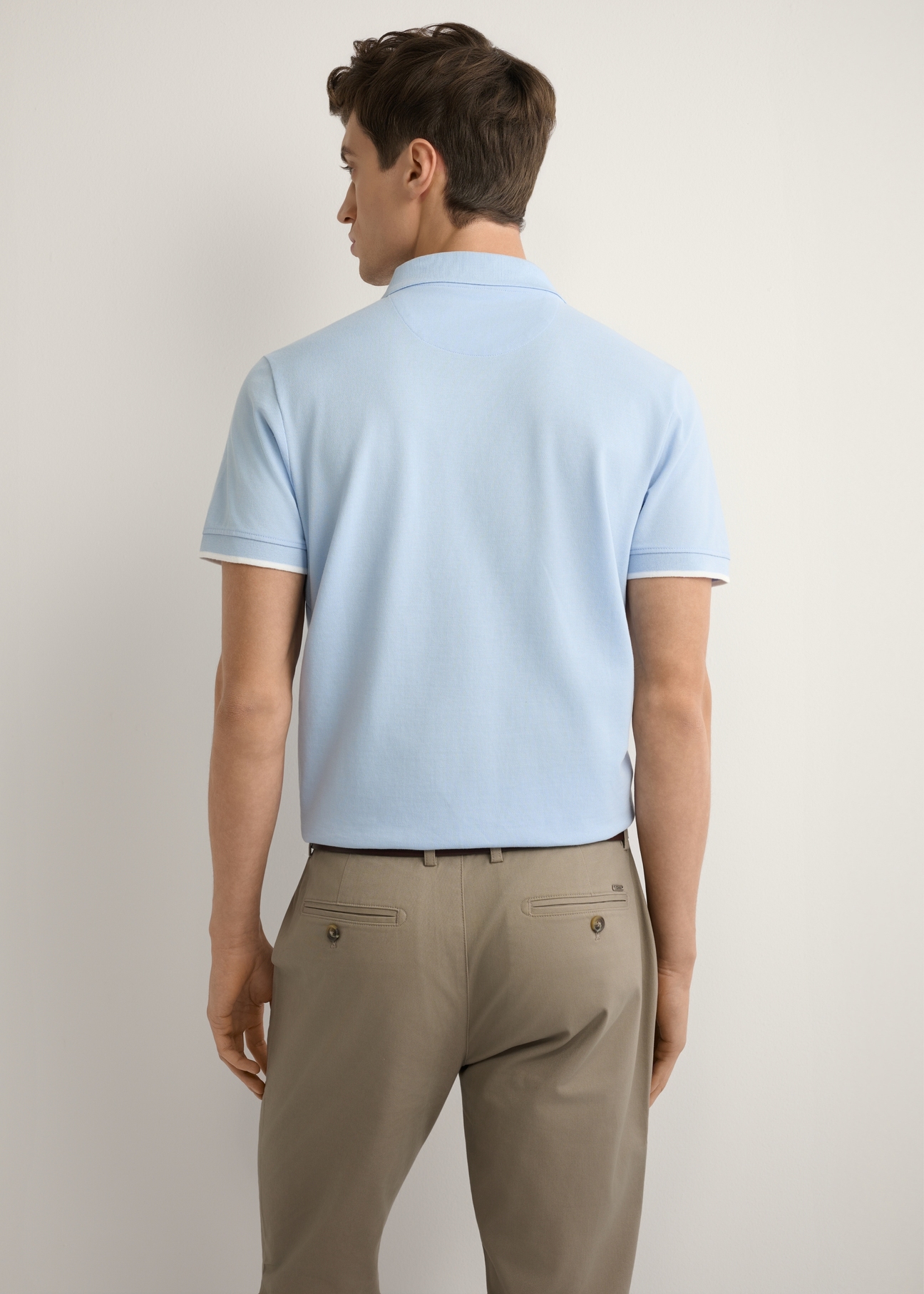 Light blue cotton polo shirt POLMT-0045B-7A(W26), back view of the product on the model. Half of the silhouette visible.