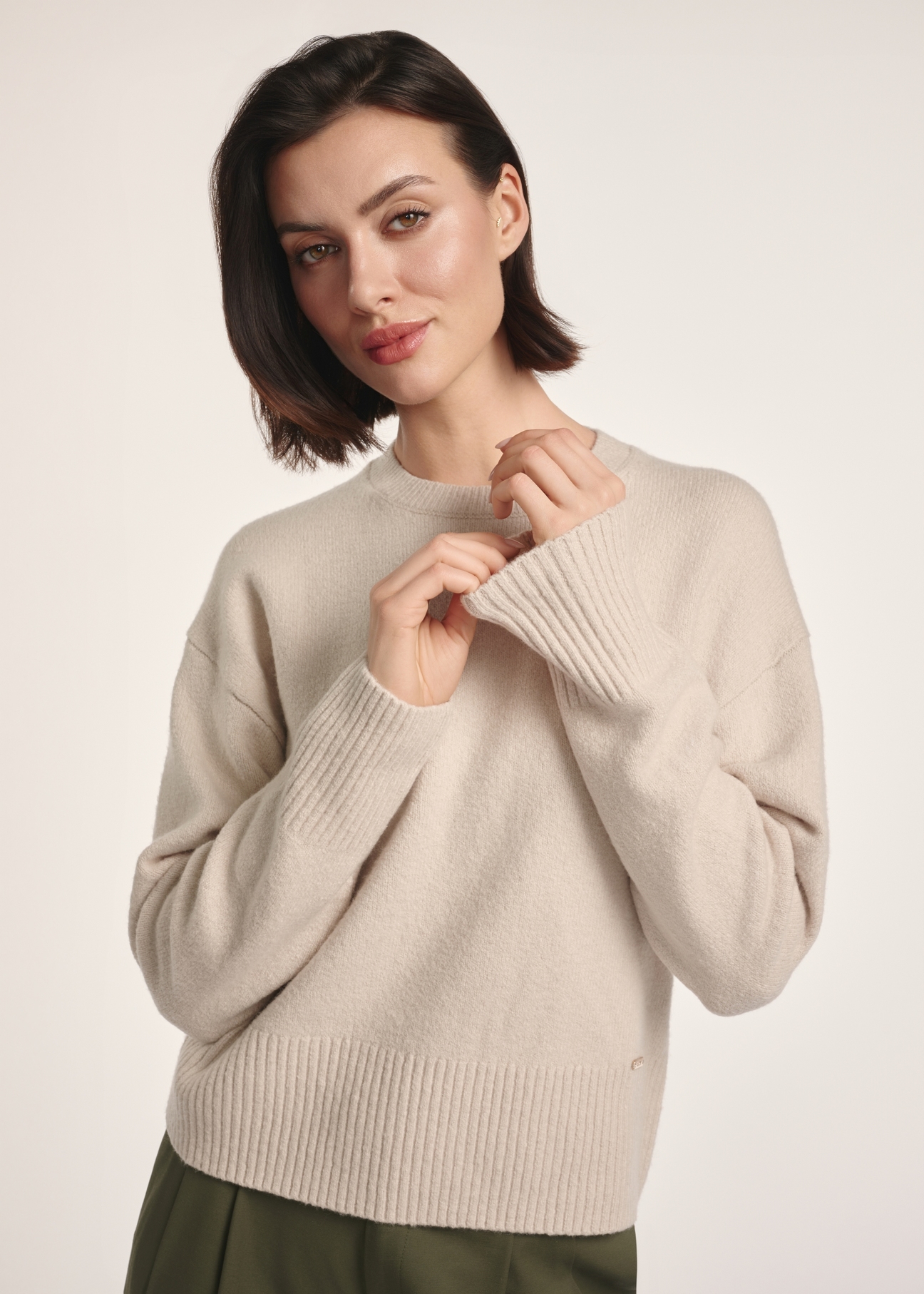 Beige women's sweater SWEDT-0242-80(Z25), front view of the product on the model. Half of the silhouette visible.