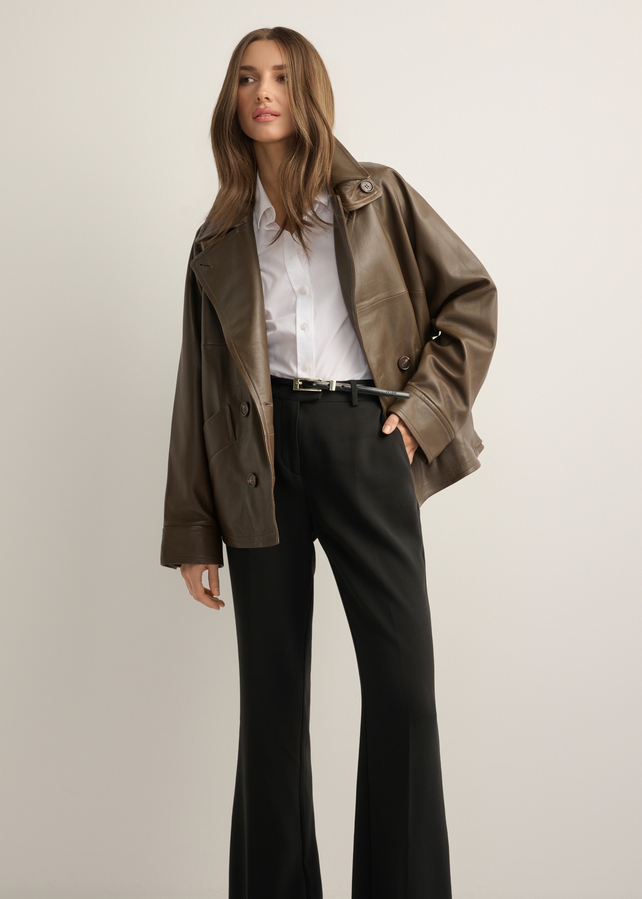 Women's oversize brown leather jacket KURDS-0592-1K(Z26), front view of the product on the model, half of the silhouette visible.