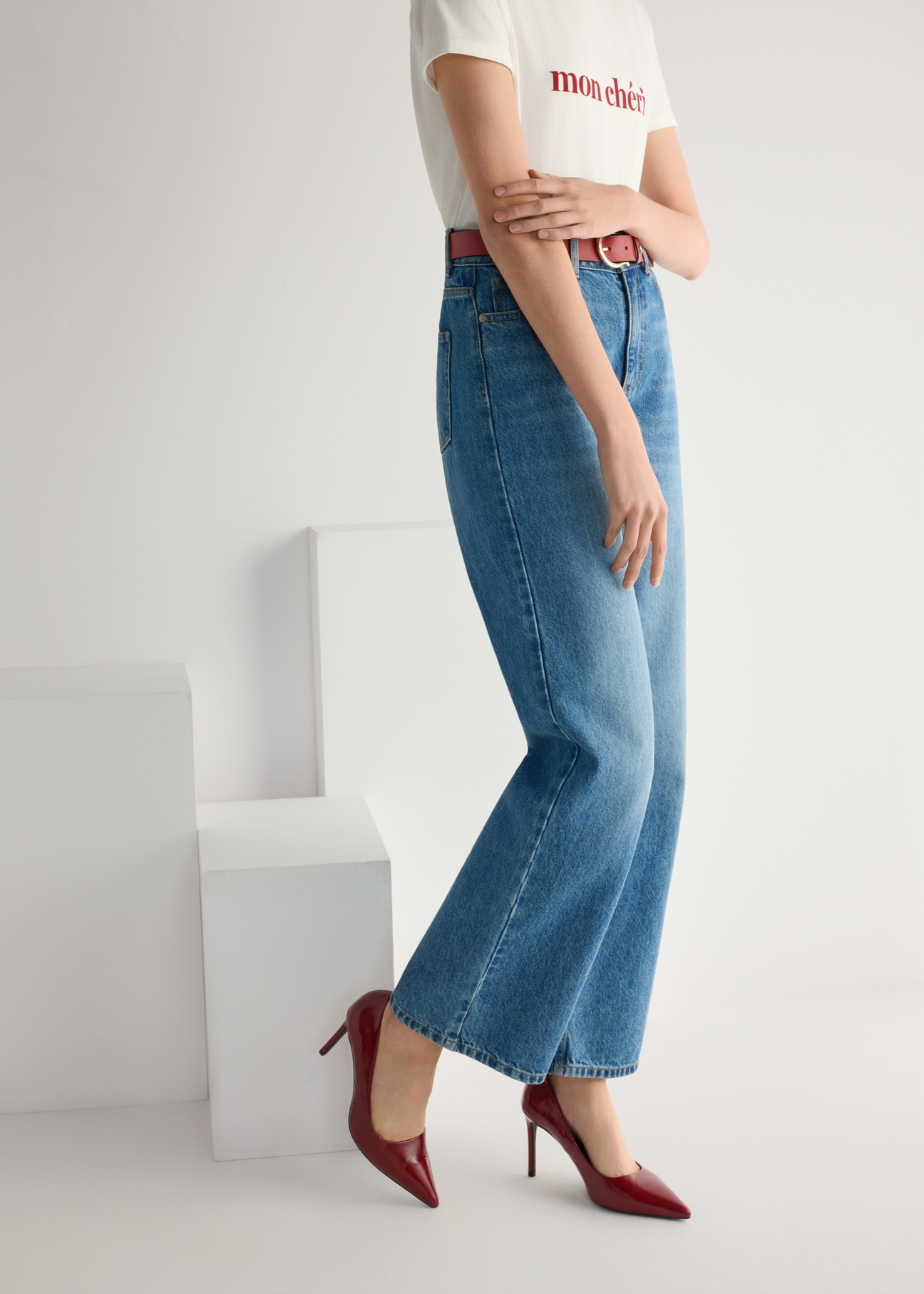 Red leather women's high heels BUTYD-1131A-4B(W26), side view of the product on the model, half of the silhouette visible.