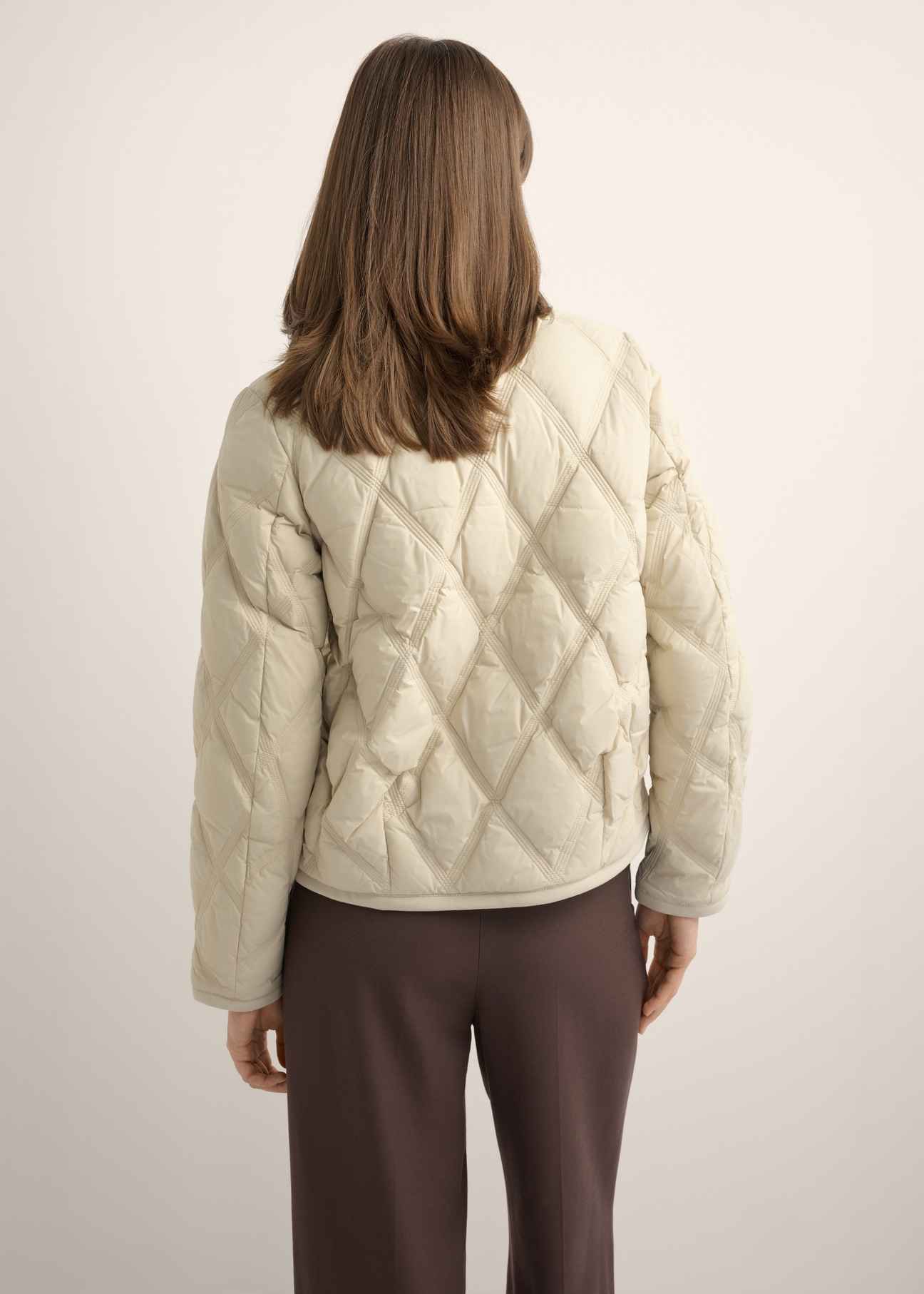 Beige women's transitional jacket KURDT-0664-1A(Z26), product view from the back on the model. Half of the silhouette visible.