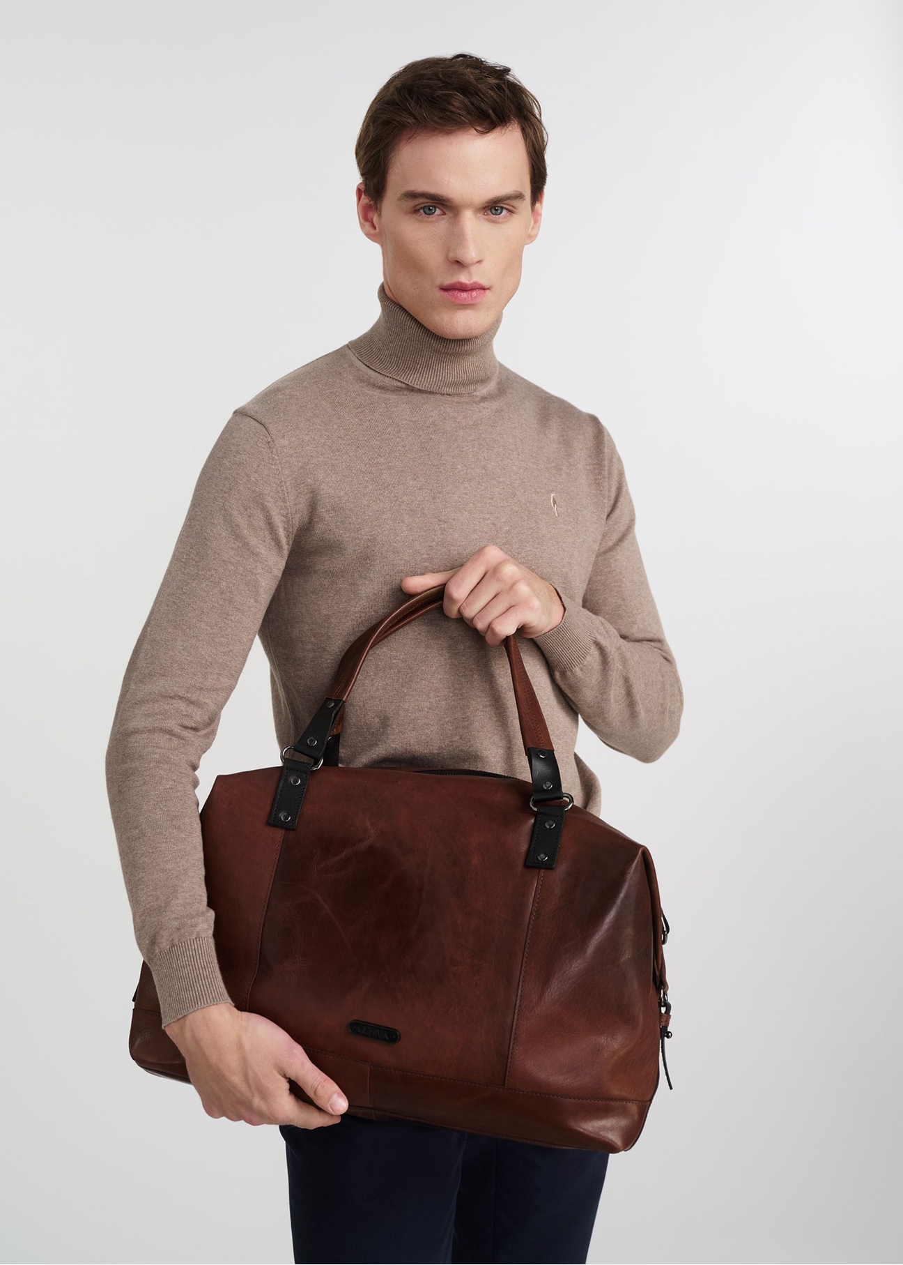 Brown leather large men's bag TORMS-0103-1H(W26), product view in model's hands, on light background.