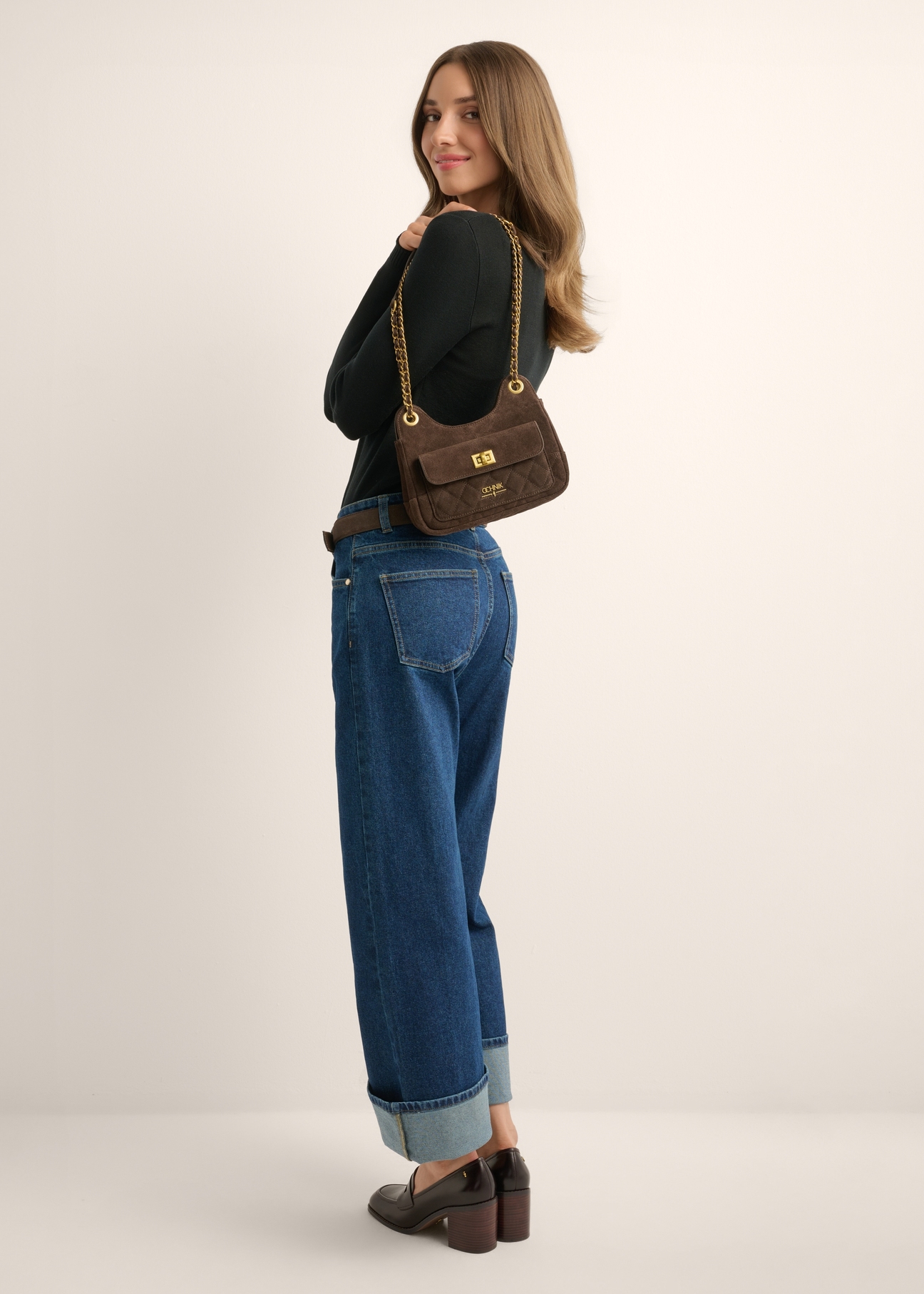 Brown suede small women's handbag TORES-1409-1I(Z26) - front view of the product, on a model, against a light background. The entire silhouette is visible.