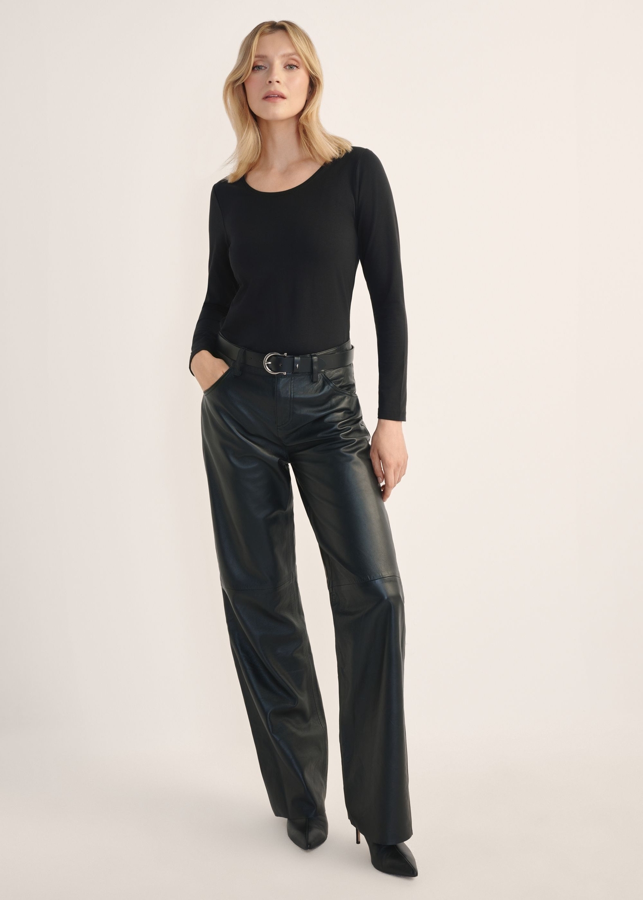Women's black wide-leg leather trousers SPODS-0038-99(Z26), rear view of the product on the model. Full body visible.